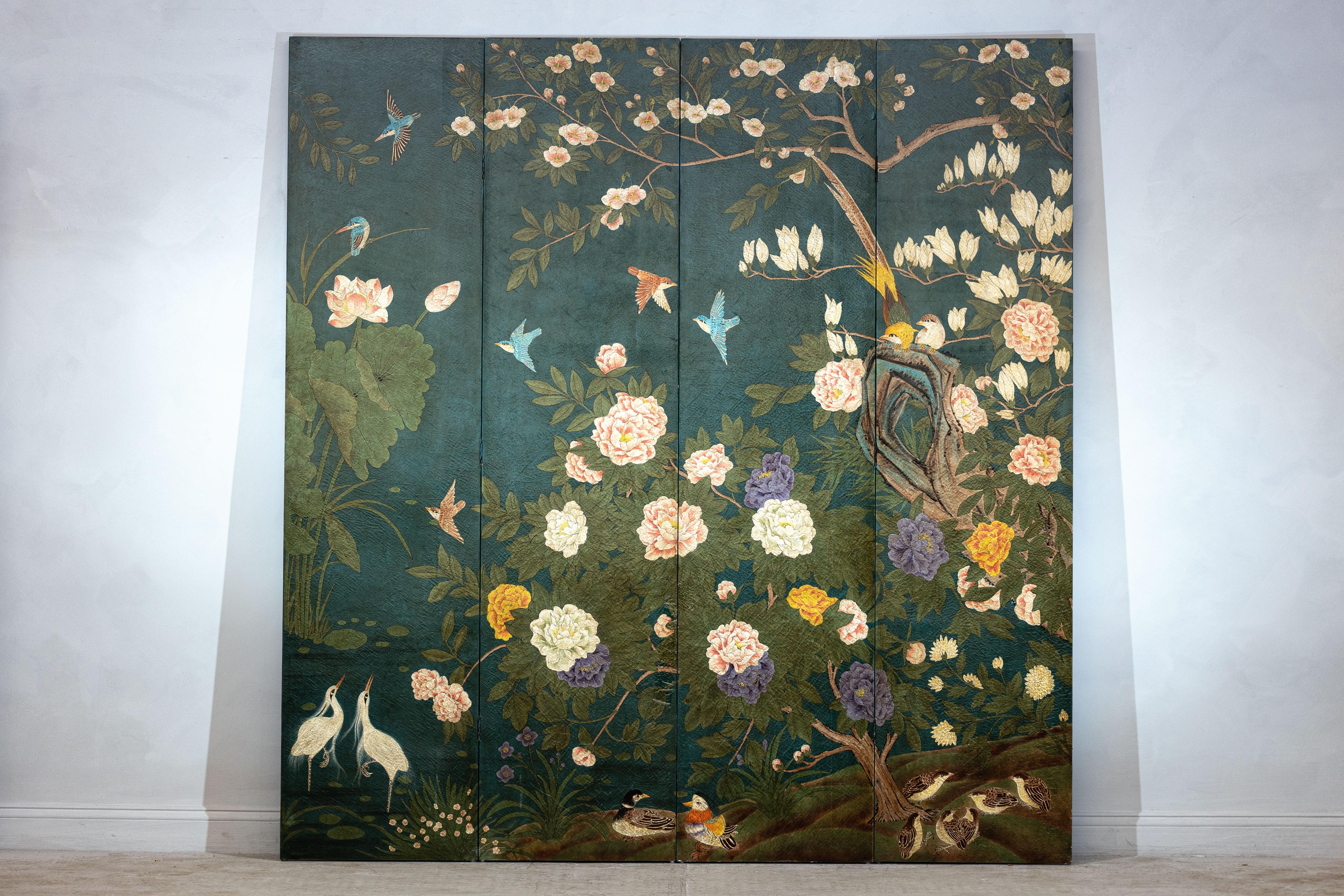 Ricamente detallado y visualmente exuberante, este biombo chino vintage de cuatro paneles está pintado a mano con una profusión de ramas floridas, pájaros exóticos y frondosa vegetación sobre un llamativo fondo lacado en verde intenso. Un armonioso