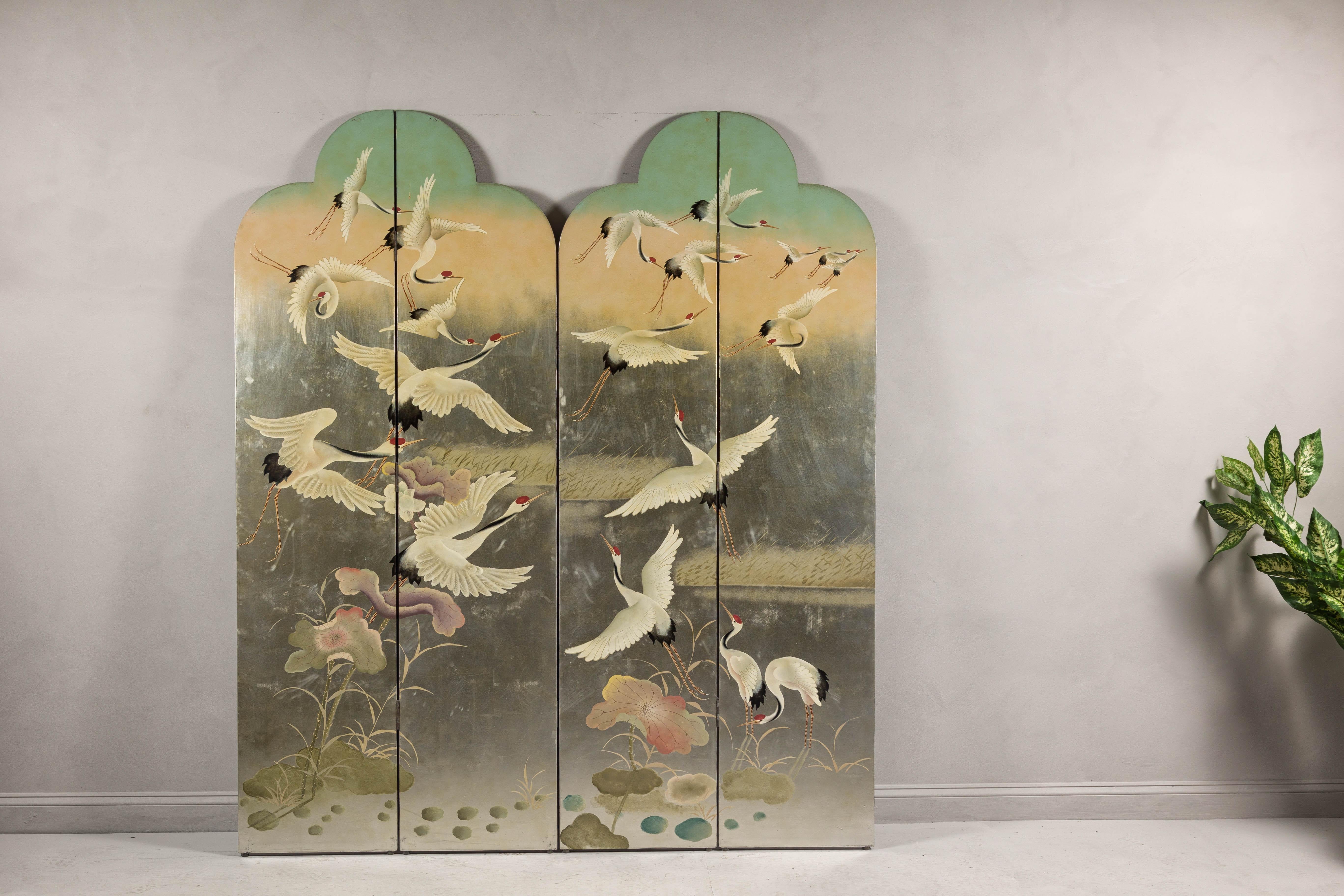 A four-panel double bonnet top multi-colored lacquered screen with flock or red crowned cranes. This exquisite vintage four-panel double bonnet top screen captivates with its multi-colored lacquered surface, depicting a serene scene of red-crowned