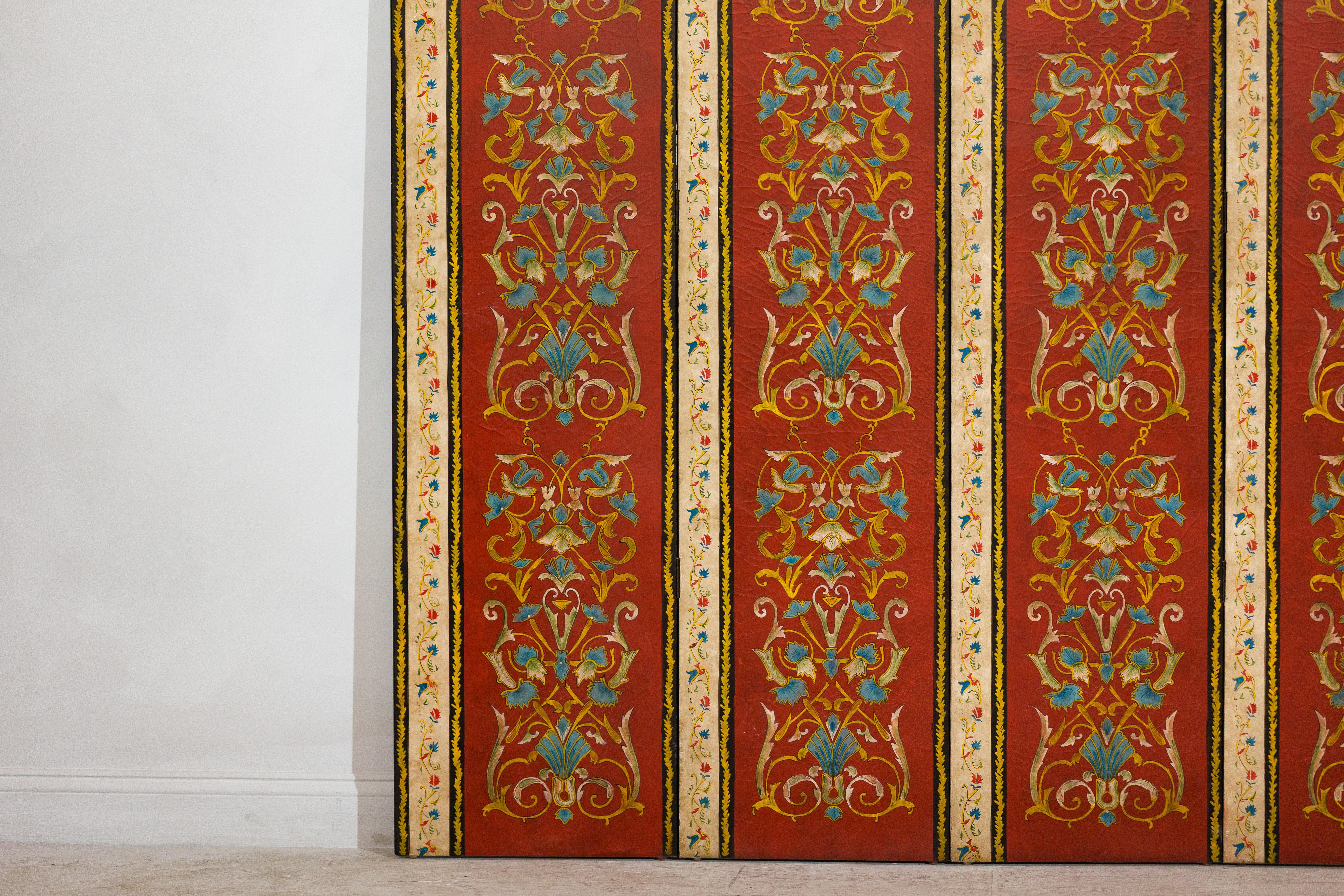 20th Century Four-Panel Red Lacquer Folding Screen with Hand-Painted Floral Scrollwork For Sale