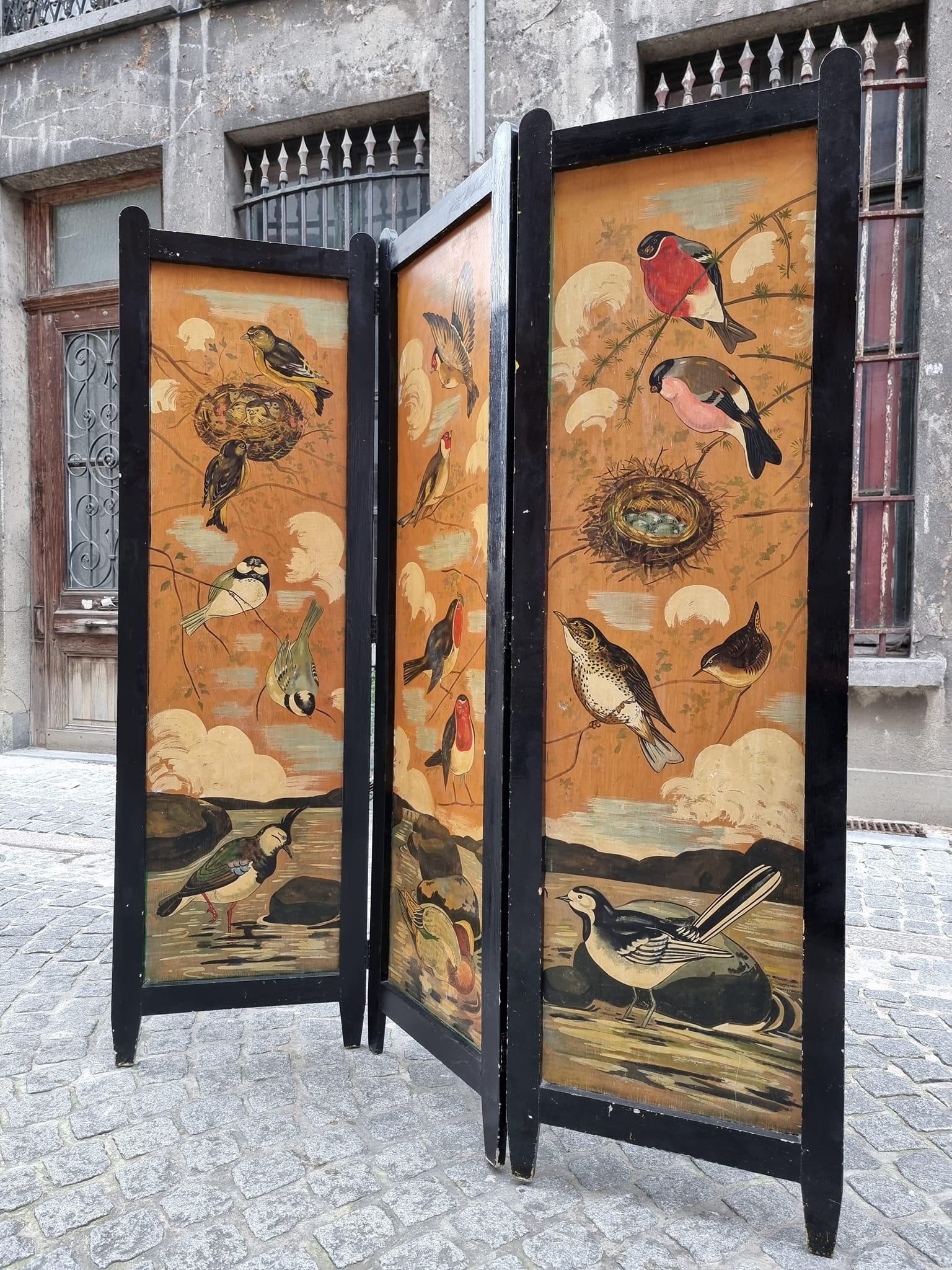 A Belgian three panel folding screen with birds.
