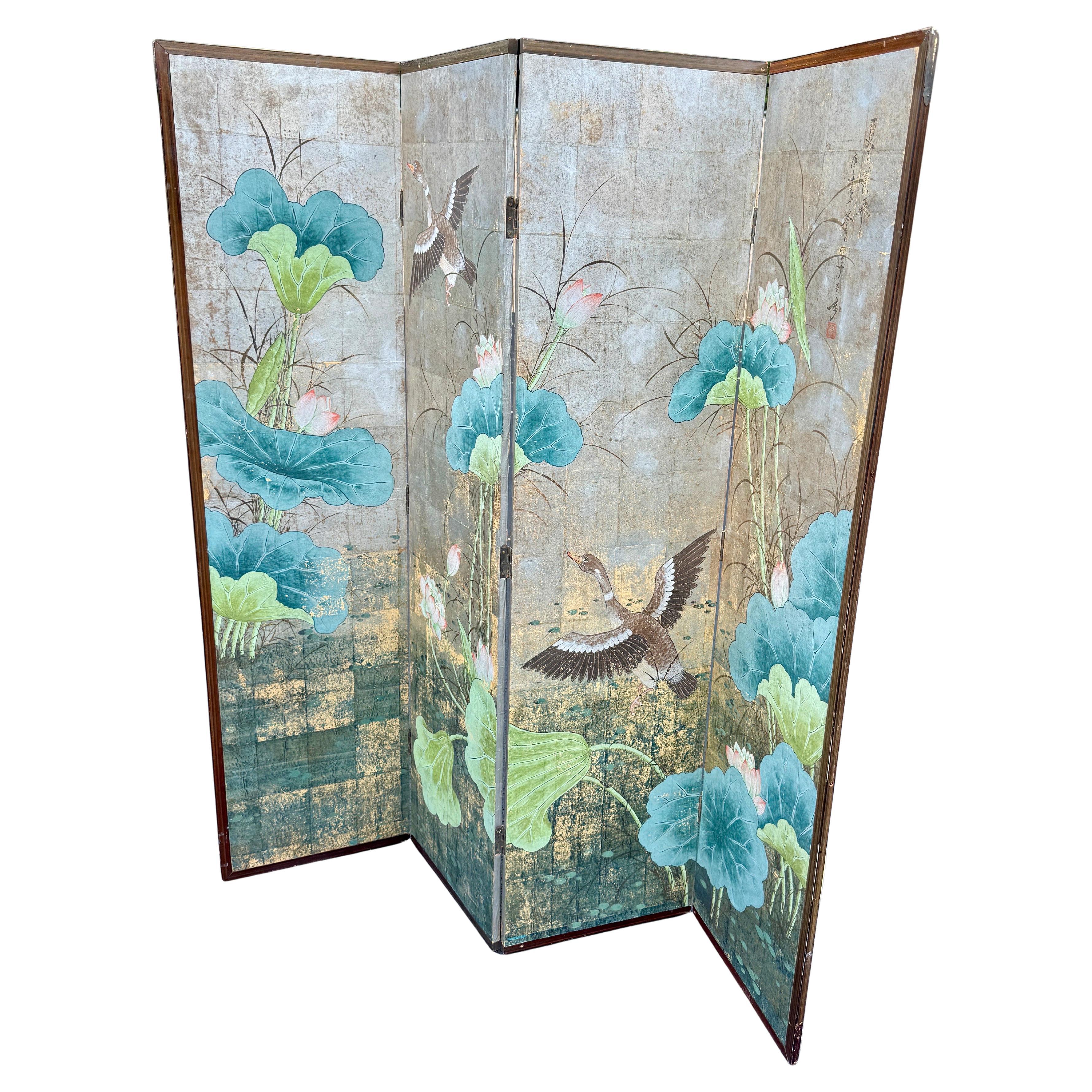 An impressive silver leafed 4 panel screen or room divider featuring flying geese, as well as blue, green and white lotus flowers throughout. This beautiful architectural screen is embossed with silver leaf, hand gilding and wood panels. Certainly a