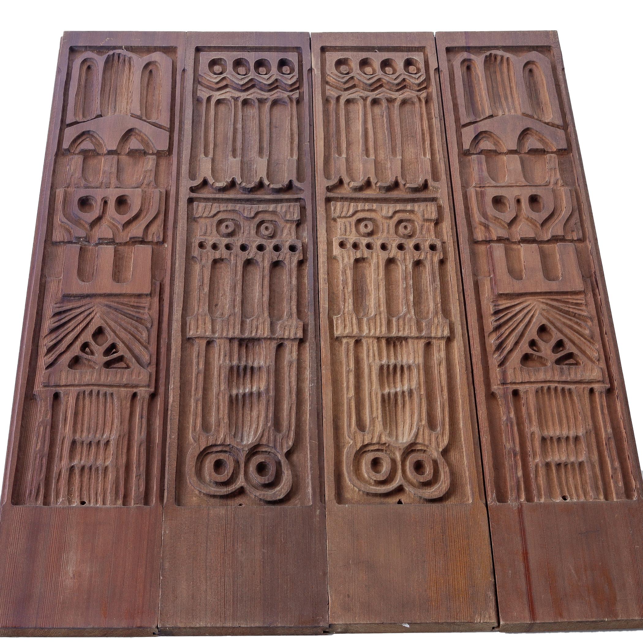 Set of four bas relief carved redwood wall panels by Panelcarve, designed by Evelyn Ackerman, circa 1967. The set consists of two pairs, with two different patterns. Each piece has a tongue and groove joint carved along each long side so that they