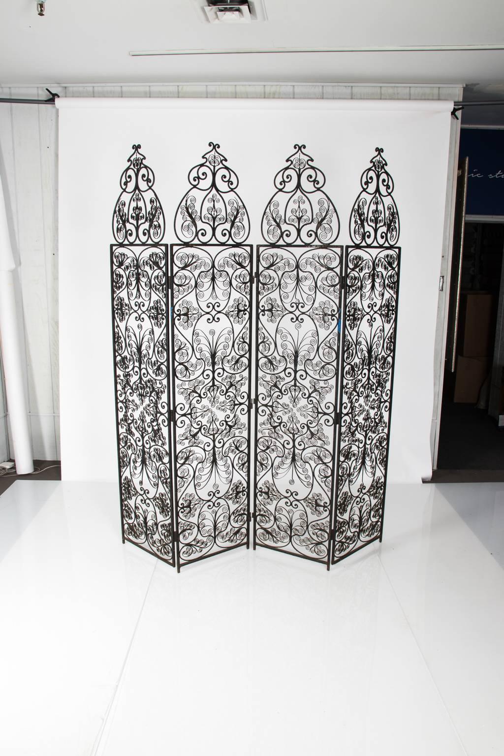 Four-paneled wrought iron screen with intricate scrollwork throughout, circa early 20th century.