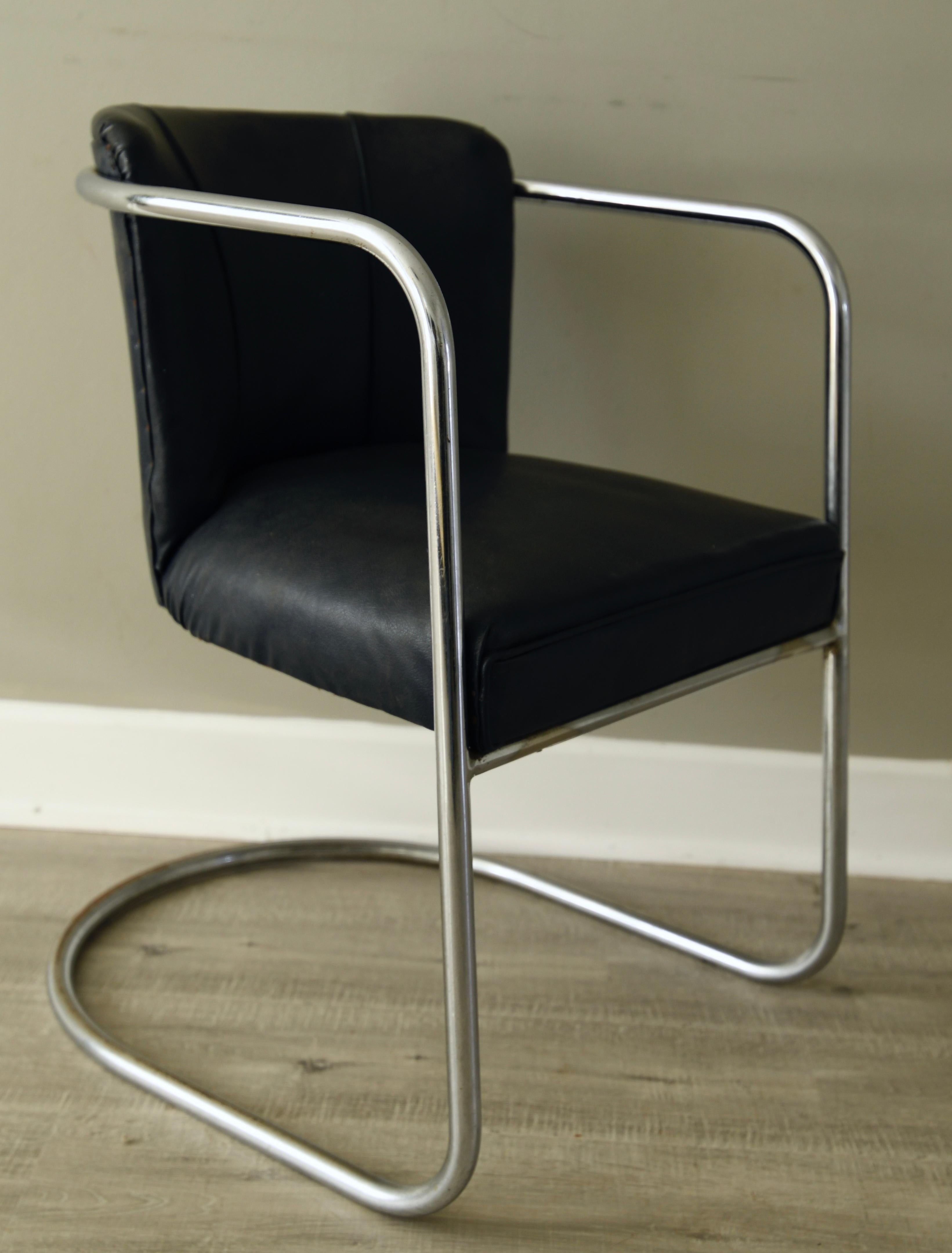 An elegant signed 1930s 1940s PEL tubular steel armchair with continuous tubular chrome horseshoe cantilever base, the steel wraps around the back and forms the armrests, upholstered in their original dark blue leatherette. The shape of the chair,