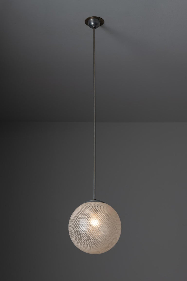 Two pendant lights by Carlo Scarpa for Venini. Designed and manufactured in Italy, circa 1940's. Venini glass, brass. Custom brass backplate. Wired for U.S. standards. We recommend one E27 60w maximum bulb per fixture. Bulbs not included. Priced and