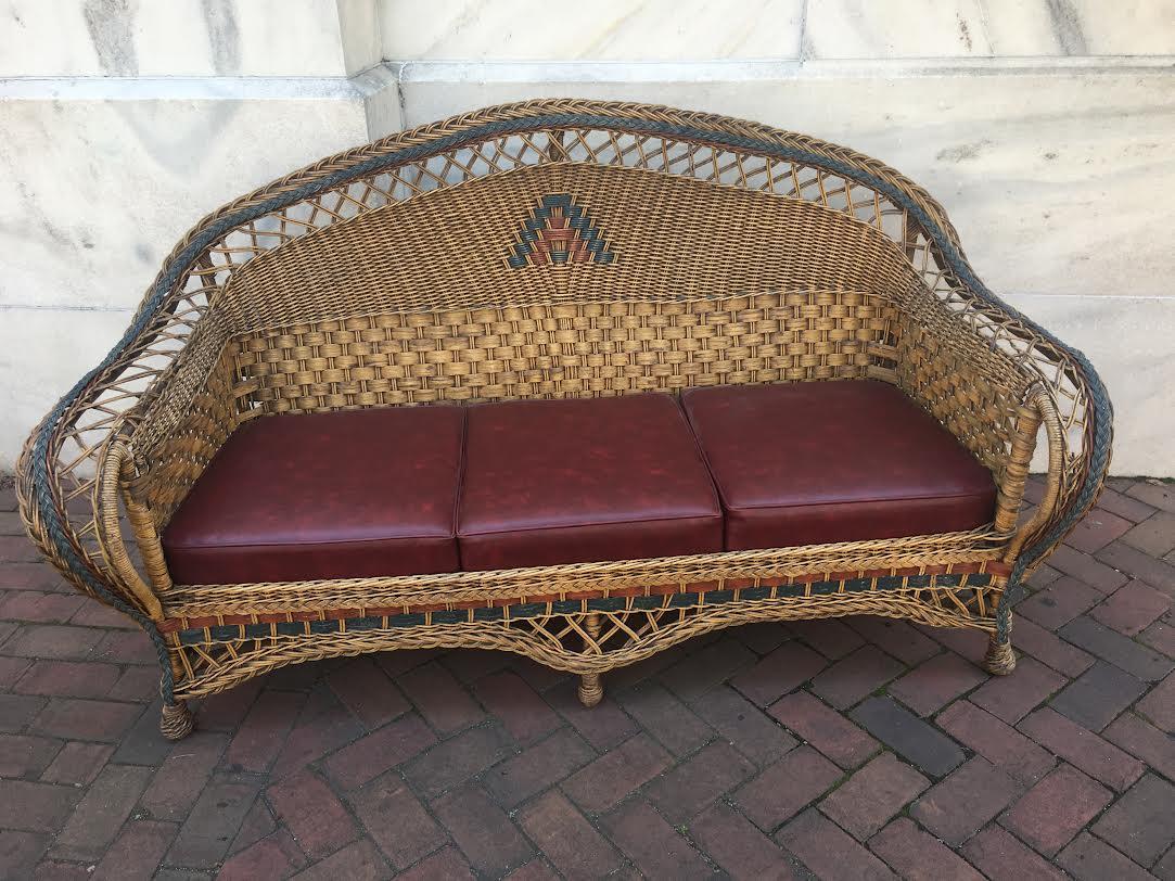 This handsome four-piece wicker suite includes a large sofa, arm chair, rocking chair and foot stool and was handmade by the Ypsilanti Reed Furniture Company of Ionia, Michigan. The company was well-known and very respected from the turn of the last
