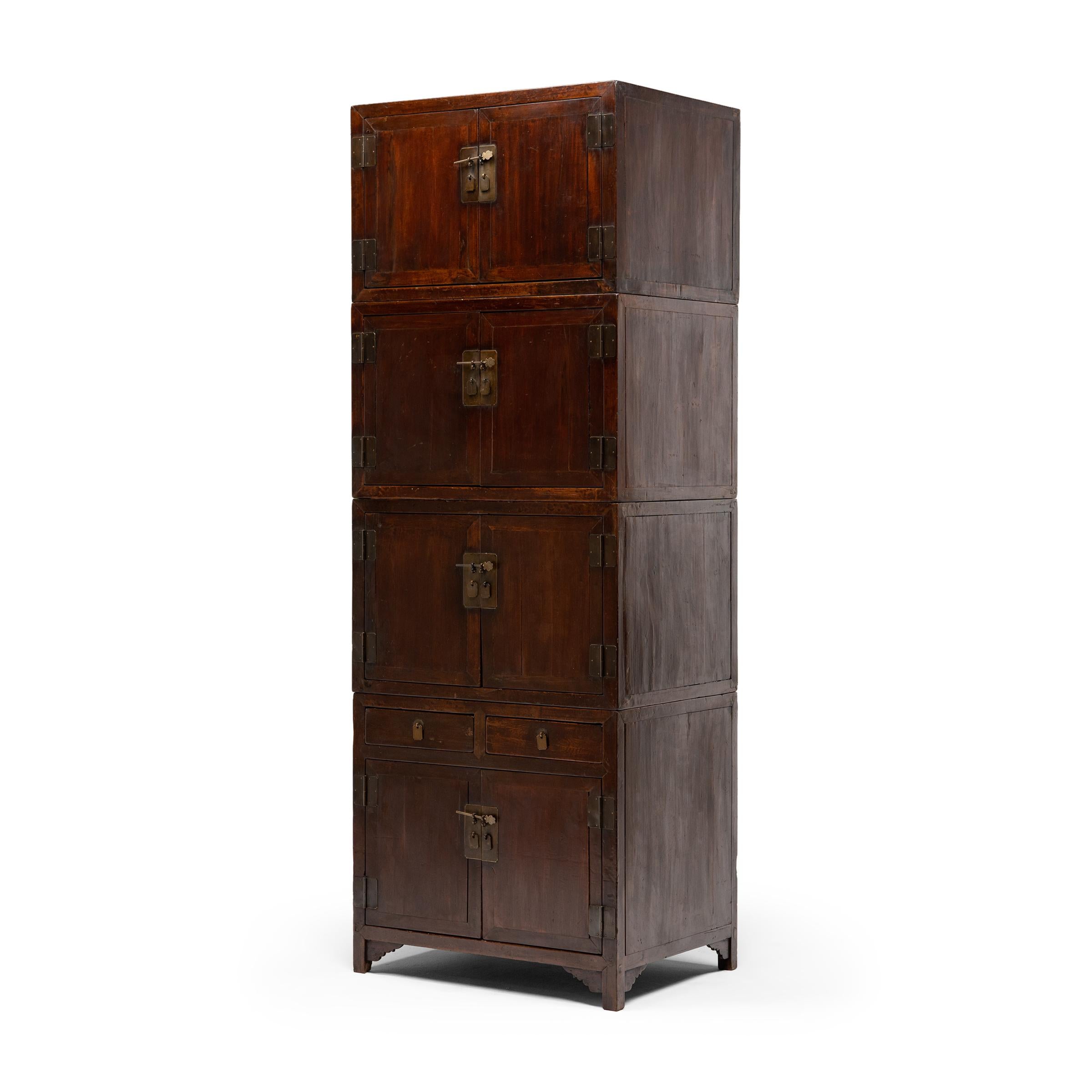 This refined, early 20th century stacking cabinet from Beijing commands its surroundings with grand scale, rich materials, and a timeless modular design. Constructed of northern elm (yumu) with traditional joinery, the cabinet is comprised of four