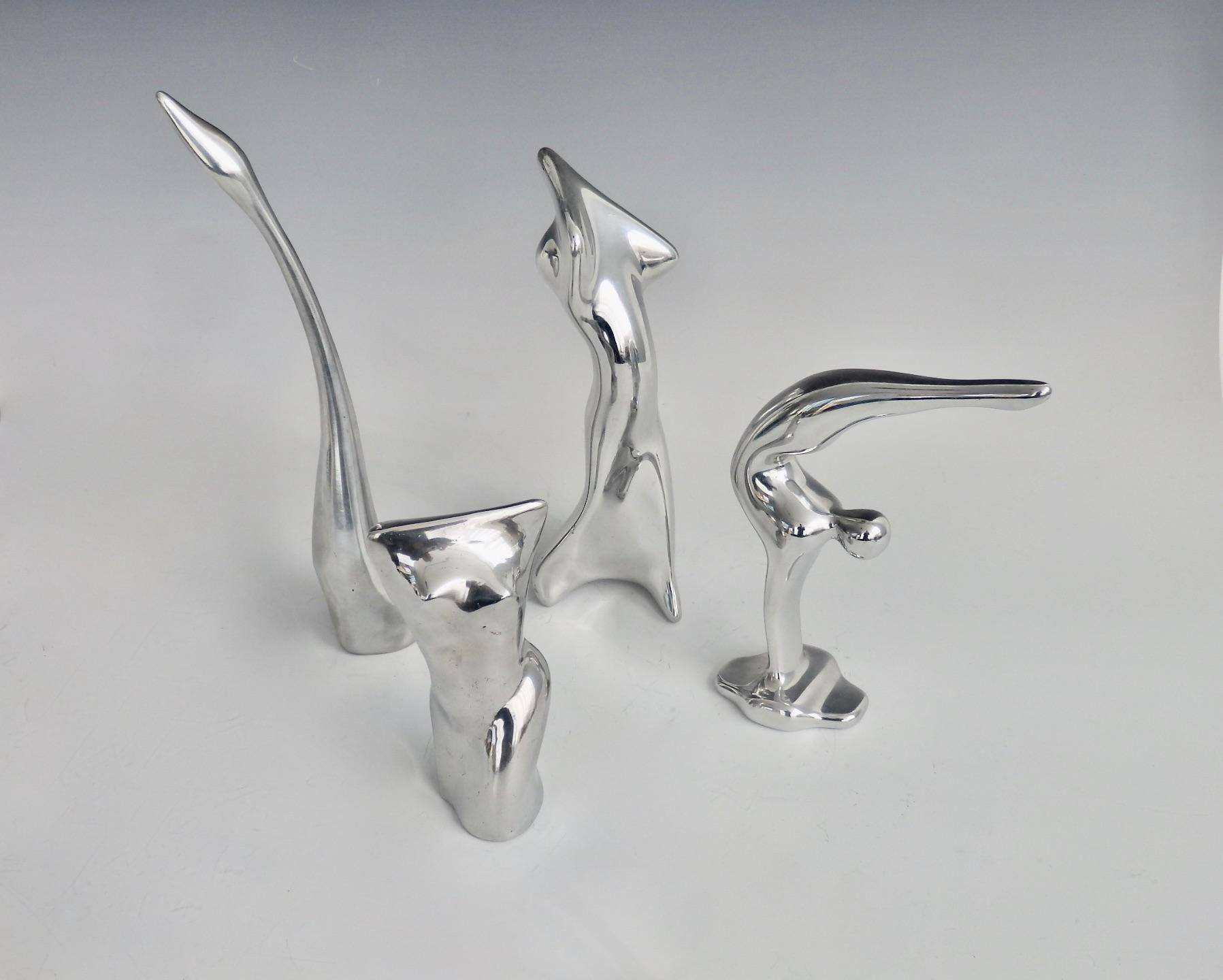 Four pieces of Hoselton stylized figures to include diver , nude torso , abstract female figure and a swan . Swan at 10.5 tall torso at 5.25 tall.