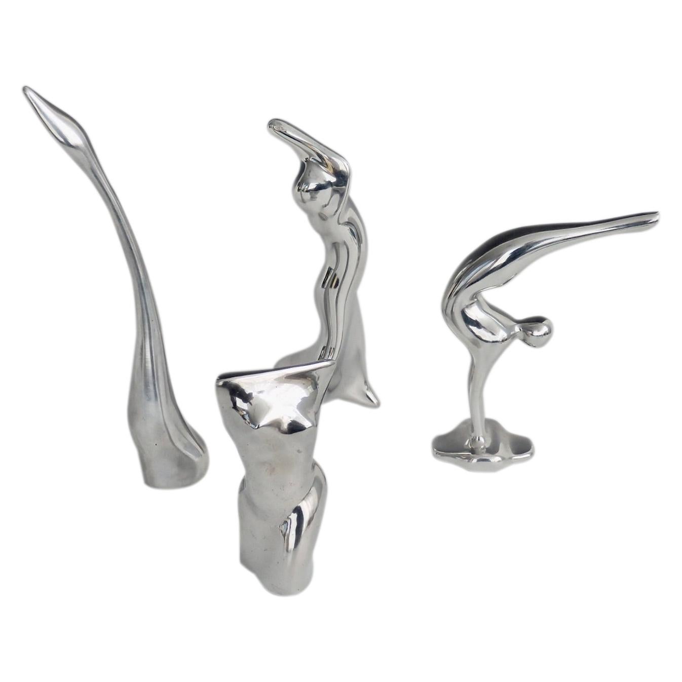 Four Piece Collection of Polished Aluminum Stylized Figures by Hoselton