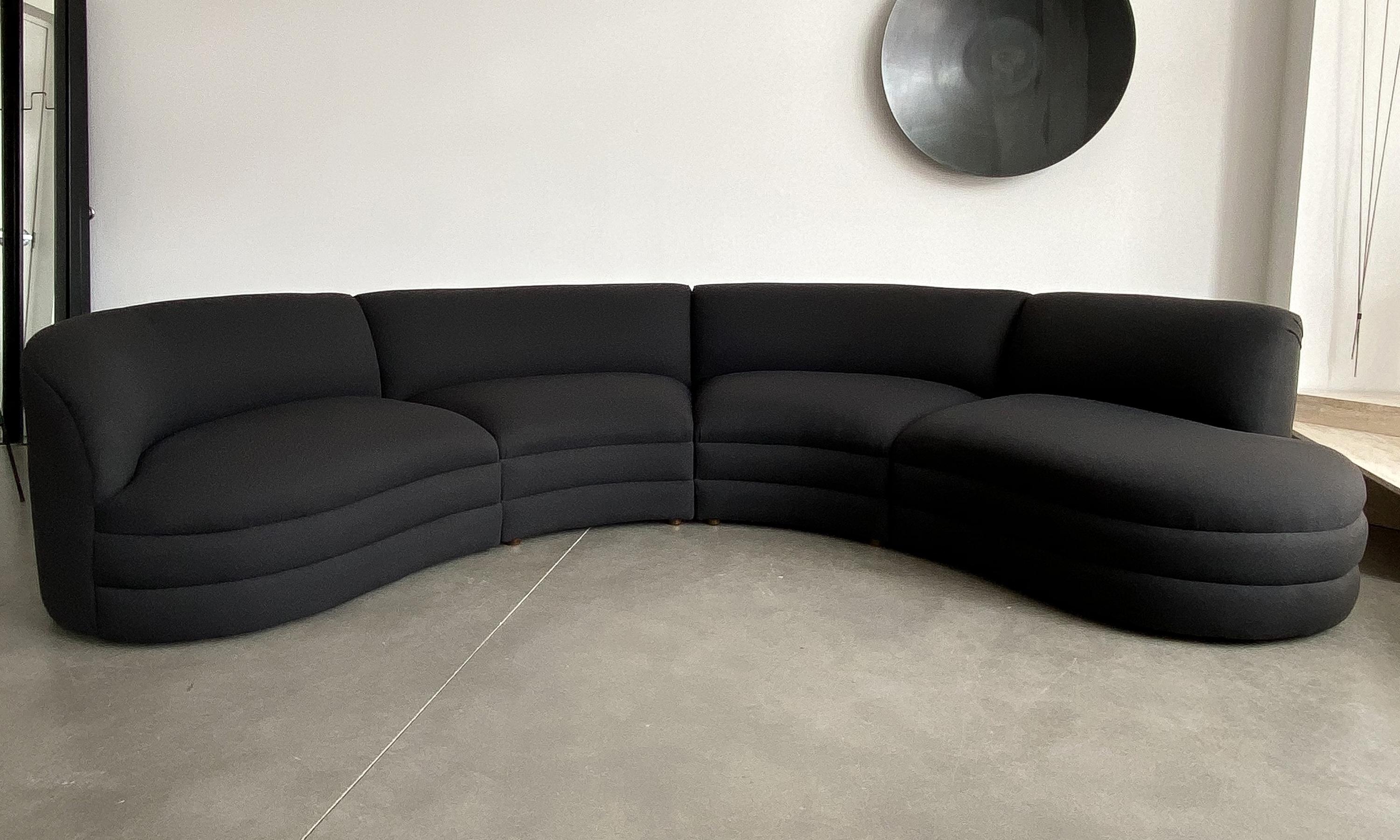 Four piece curved sectional sofa attributed to Vladimir Kagan for either Directional or Weiman, circa late 20th century. Upholstered in the original black fabric. Upholstery is in good condition but shows some fading along back and some