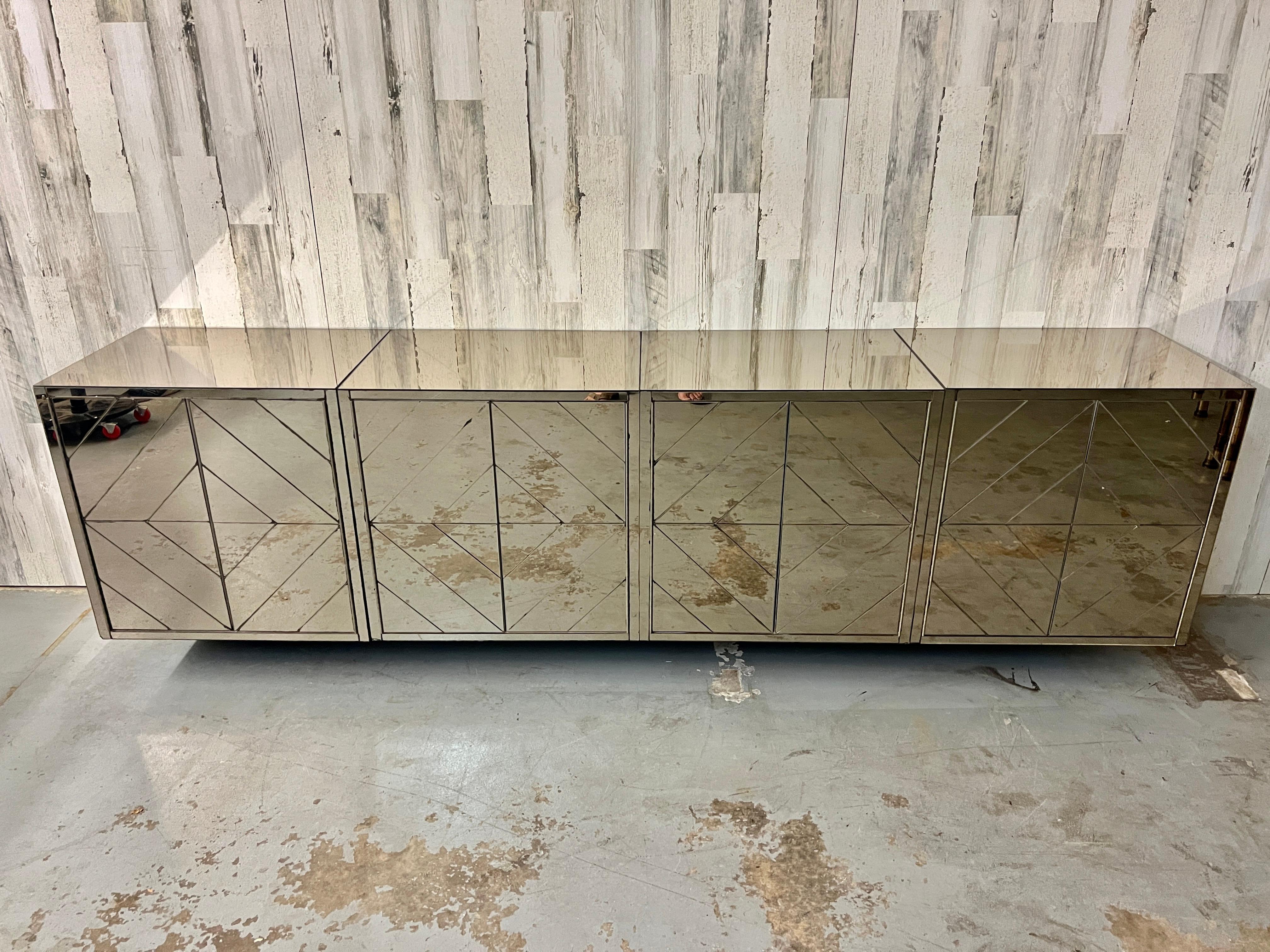 Giant Mirrored Diamond pattern floating credenza. These pieces can be hung together or separated into any configuration. They can also be hung at any hight making them very versatile for any space. This fully mirrored credenza has a very 1970s look.
