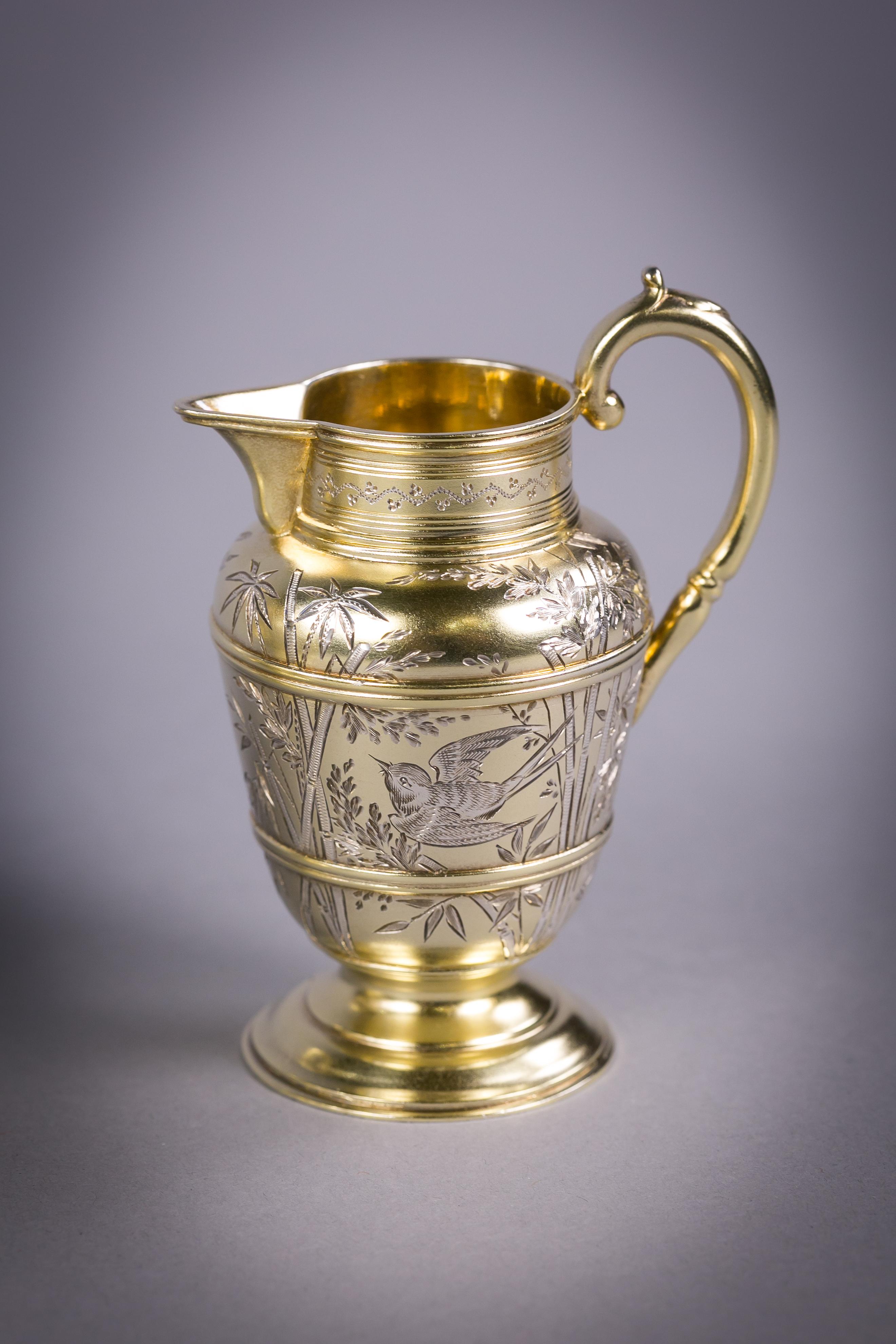 Marked: London, 1878, Maker: Frederic Elkington. Comprising a teapot, cream jug, sugar bowl and pair of sugar tongs. Finely engraved in Japanese taste with beards and bamboo.