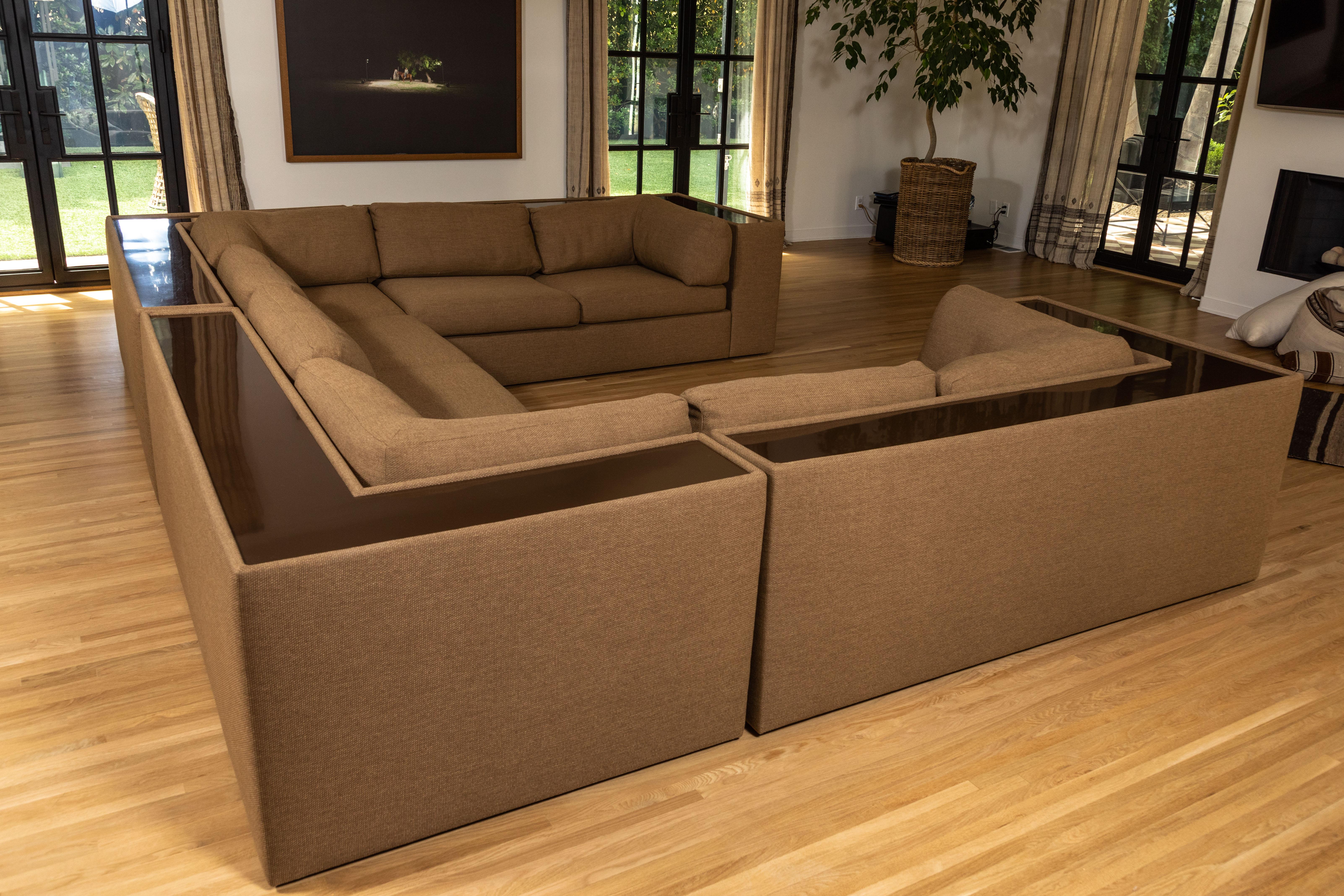 Magnificent Milo Baughman sectional sofa, newly upholstered in Kravet performance fabric. Four pieces offer options for configuration. Brown continuous original polymer shelf at back highlights the neutral textured upholstery. Measurements are for