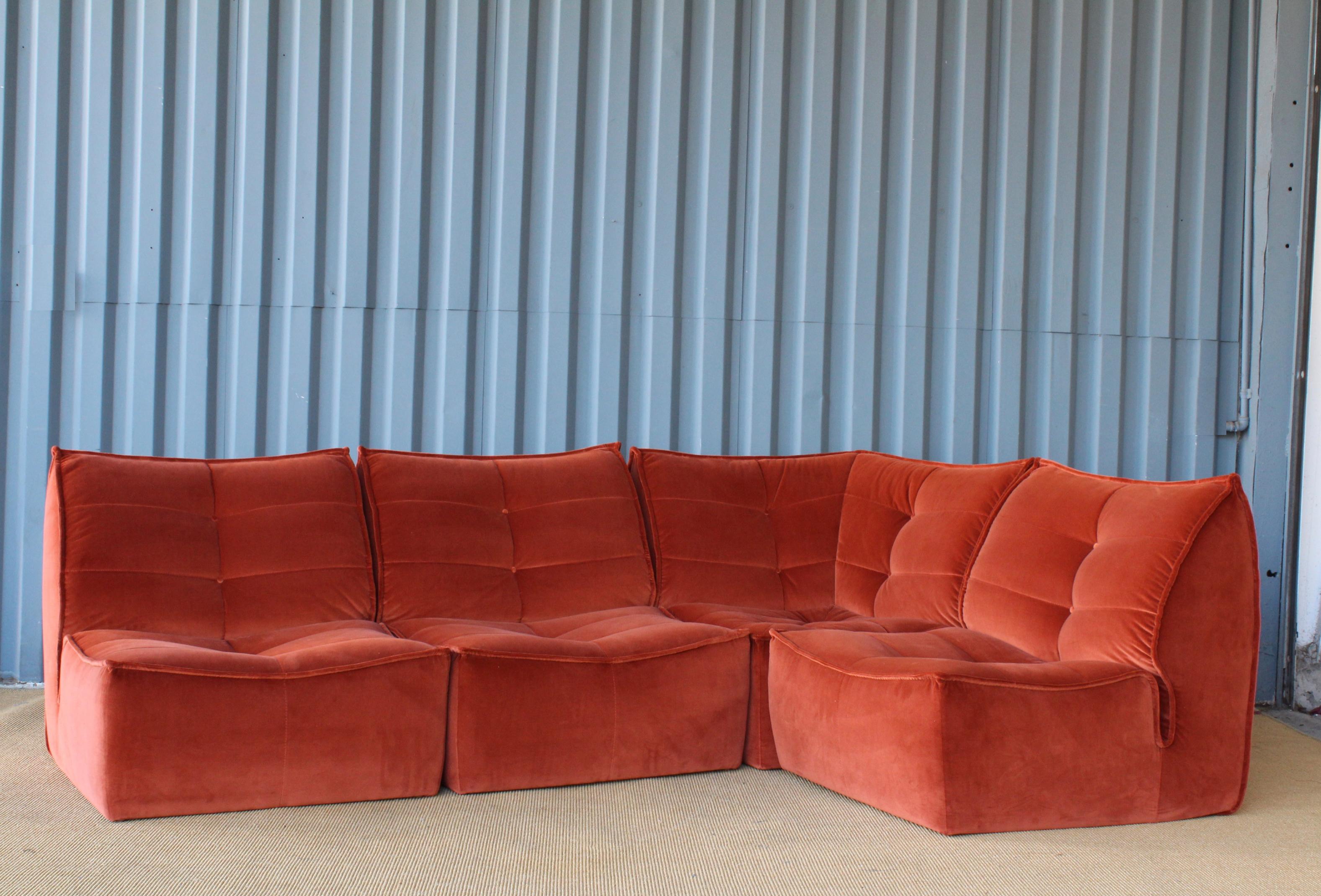 1970s Italian made modular sofa with new burnt orange velvet upholstery. With all four pieces combined this sofa measures 95 inches by 66 inches.