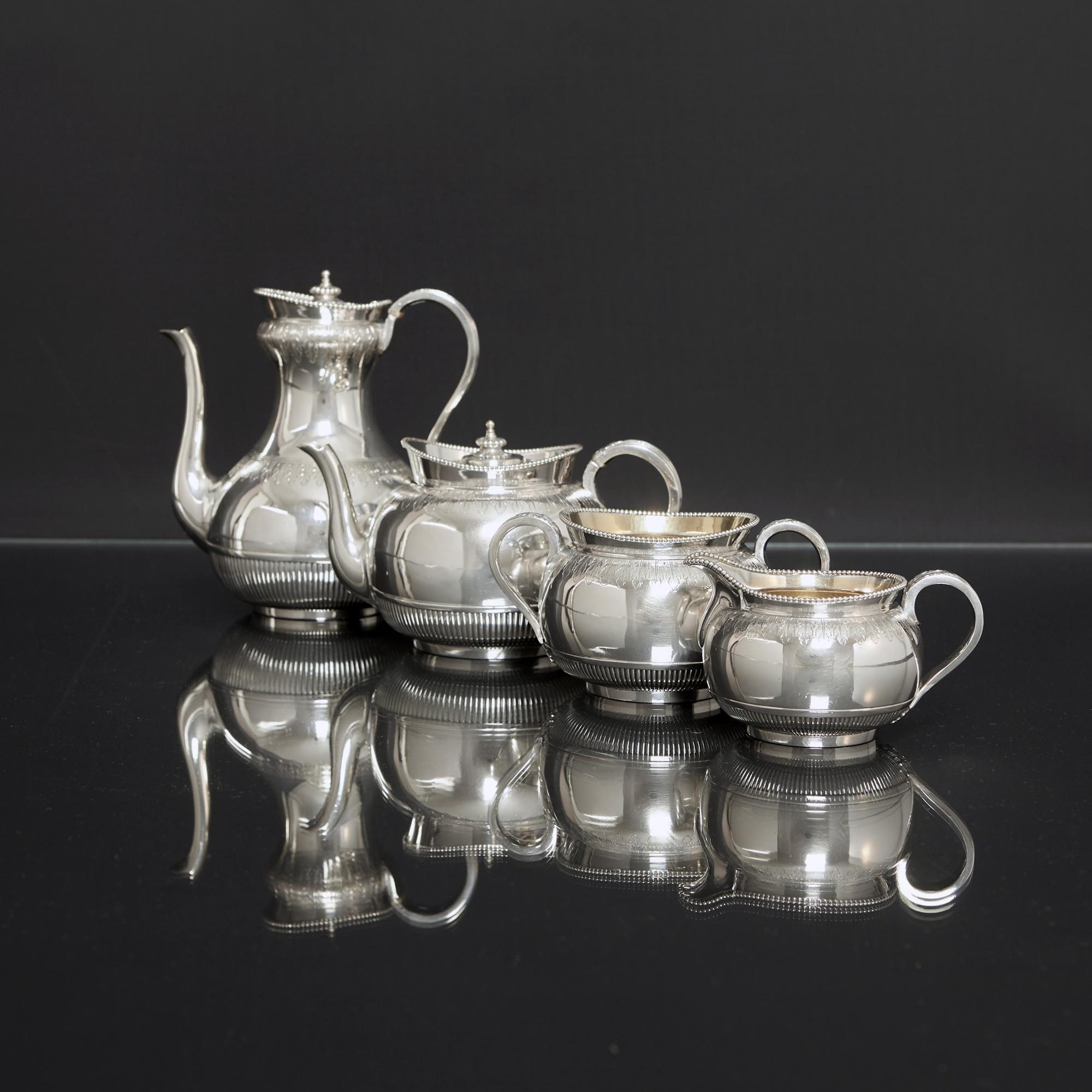 Smart four-piece Victorian antique silver tea and coffee set. Each piece is hand chased and engraved with acanthus leaf aprons, fine fluting around the base of the body, and an elegant bead pattern rim. The hinged covers of the silver tea and coffee