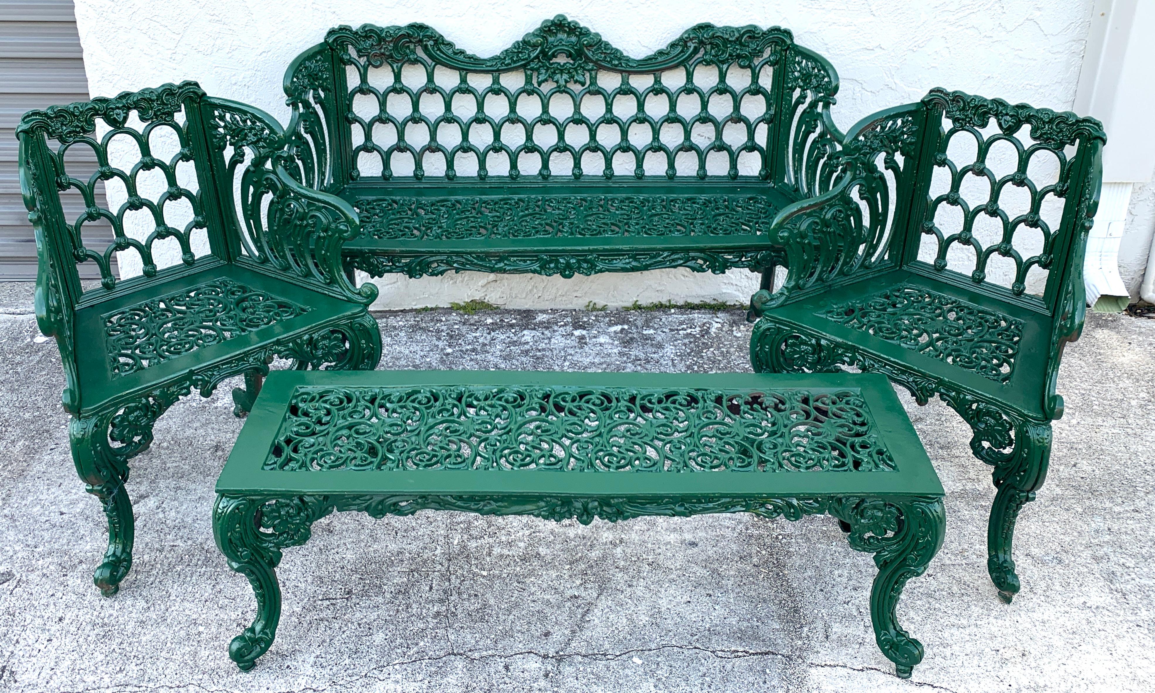 Four-piece Victorian style garden/ Patio set, provenance Celine Dion,
of cast aluminum, with stylized horseshoe motif. Consisting of a settee, pair of garden chairs and a long bench or table, painted in green
Settee measures: 60