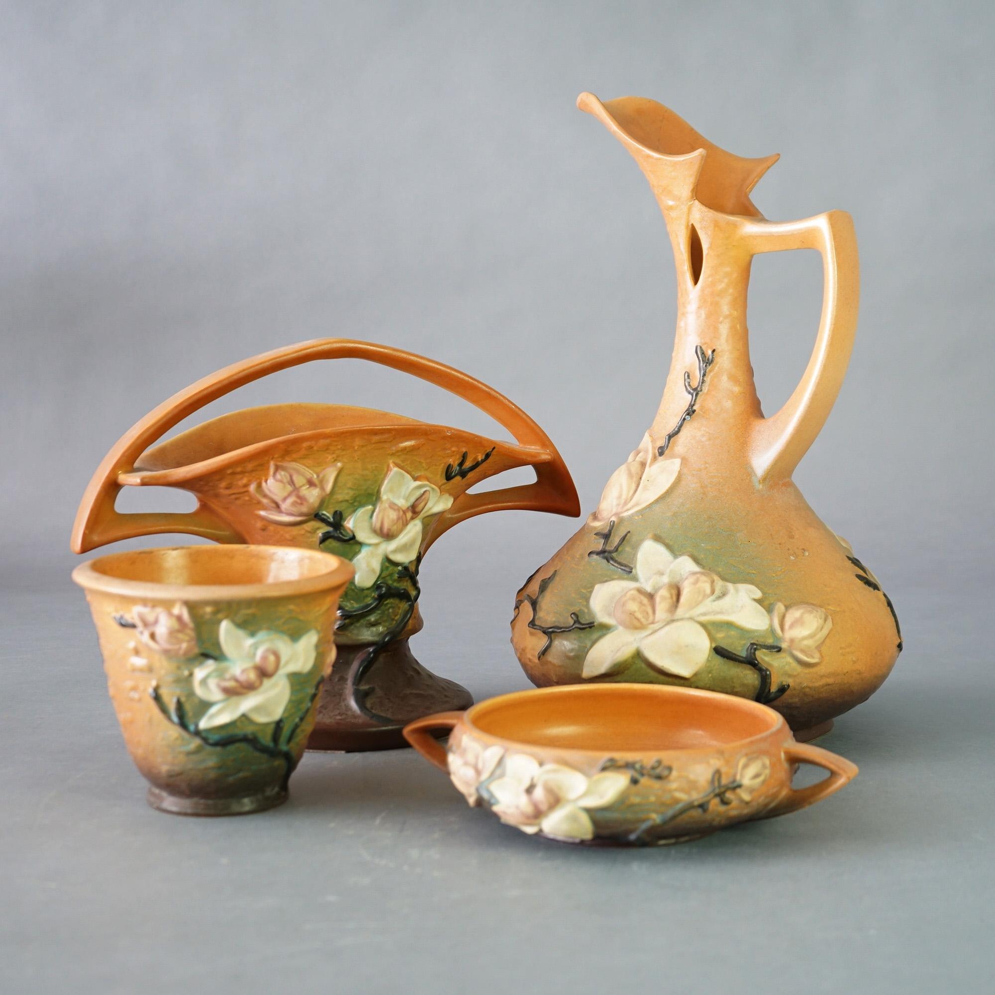 Four Pieces of Brown Roseville Art Pottery with Magnolia Pattern Mid 20thC

Measures- Pitcher: 16''H x 9.25''W x 9.25''D; Handle Basket: 9.75''H x 12.75''W x 6.5''D; Flower Pot: 5.25''H x 6'' diameter; Lo Flower Pot: 8''H x 10''W x 8''D