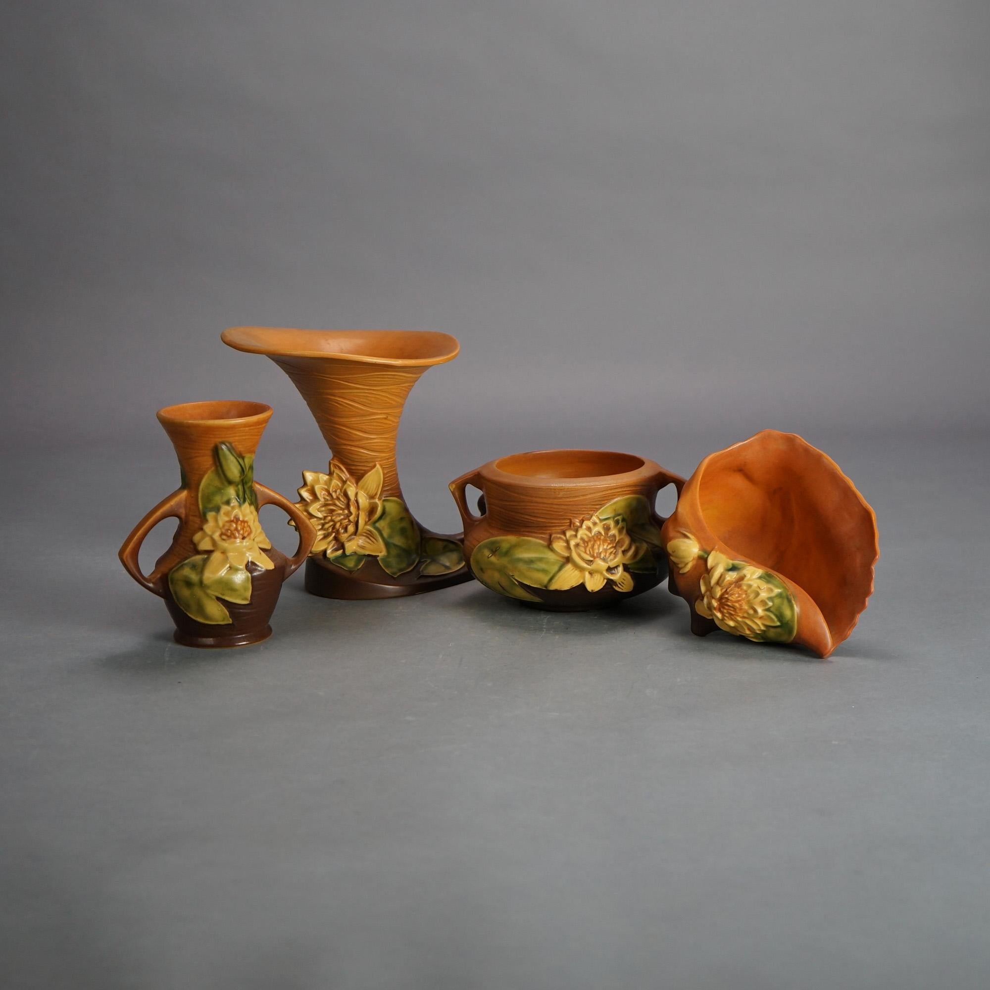 Four Pieces of Brown Roseville Art Pottery with Water Lily Pattern Mid 20thC

Measures - 7.75
