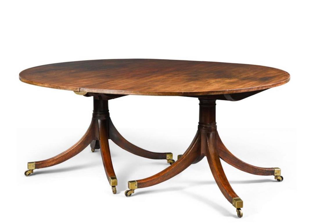 Four pillar Georgian dining table plus the tops and the three extra leaves in excellent condition and color. A magnificent example of a George III dining table in original condition and color.