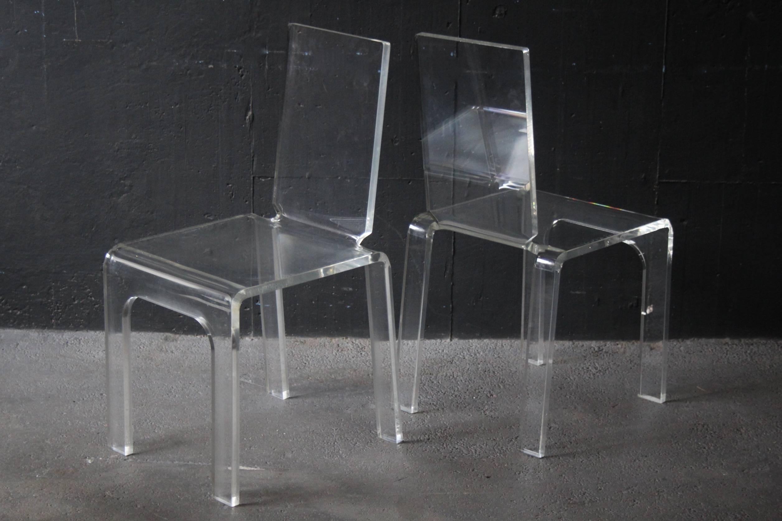 Four plexiglass chairs.