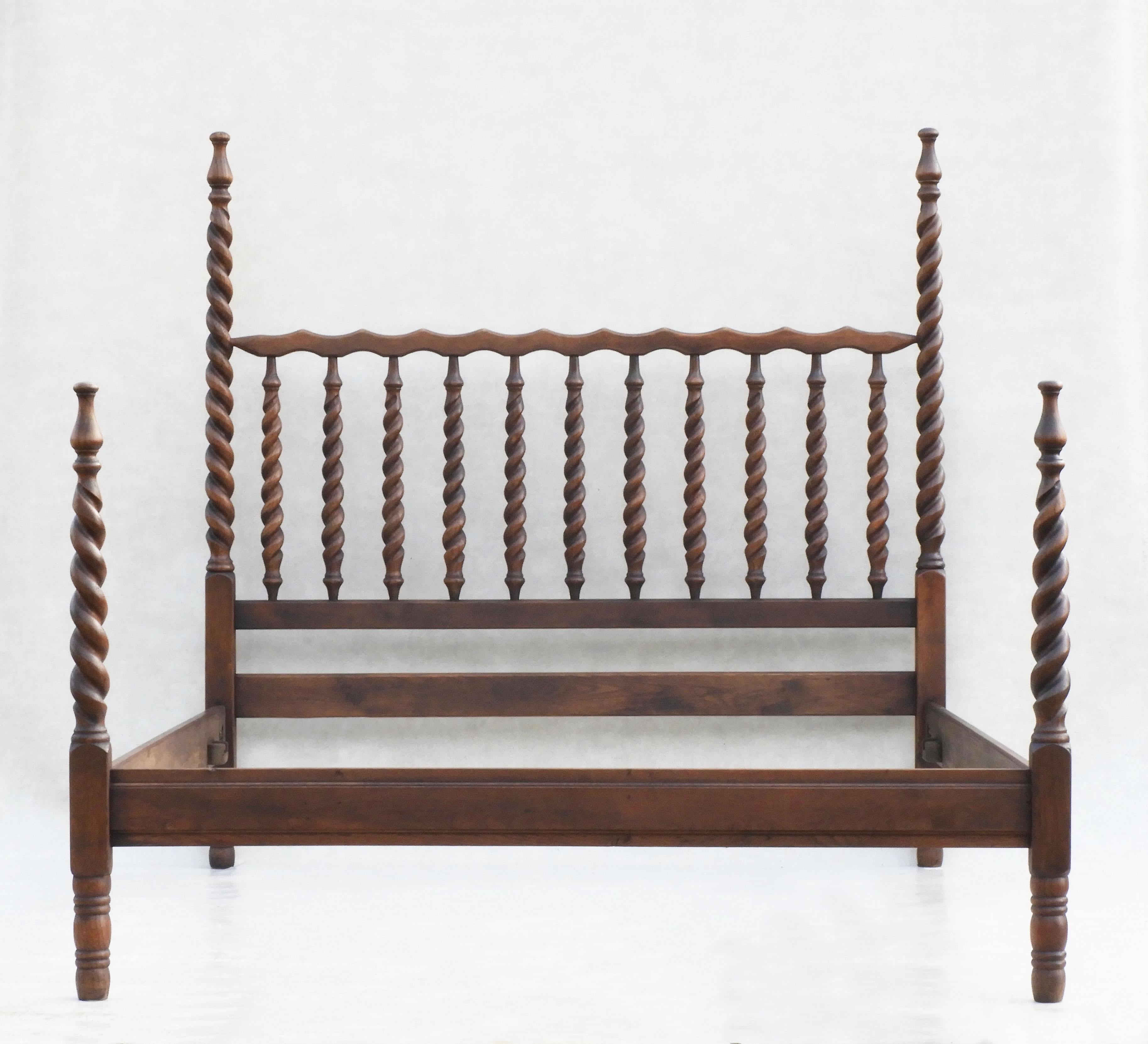 Beautiful oak barley twist four post bed C1920s Spain.

Artisan-crafted turned wood bed with carved torsade posts at each corner and the spiral theme continuing through to the headboard.  In great condition with good patina, solid and sound with