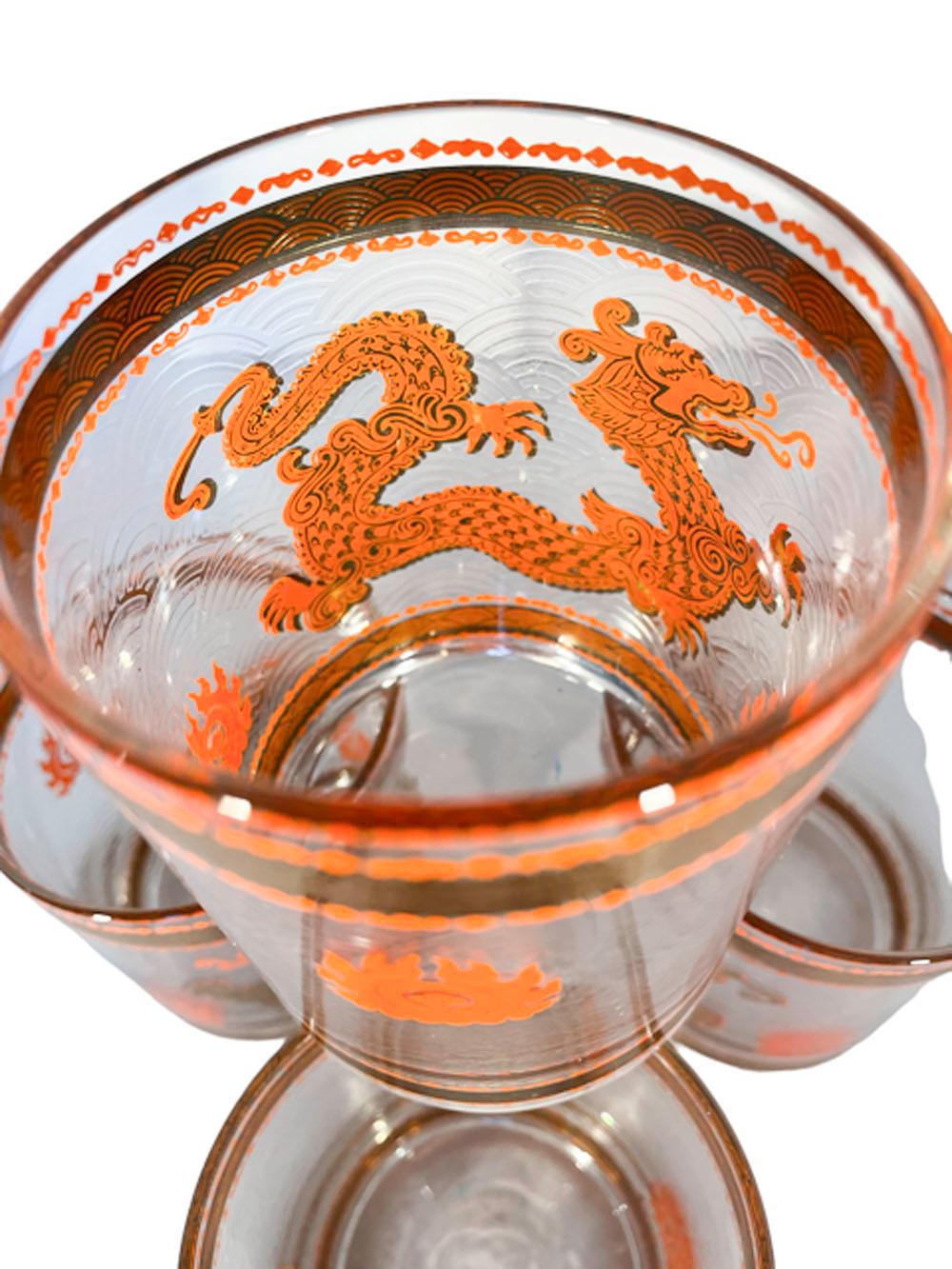 Vintage rocks glasses by Cera Glassware in the hard-to-find Golden Dragon pattern - decorated in 22k gold and orange enamel with a large dragon pursuing the flaming pearl of wisdom against a ground of translucent stylized clouds.
 