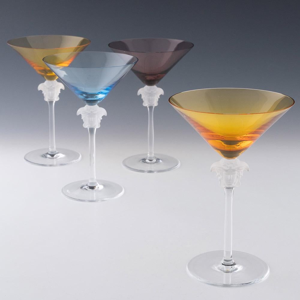 Heading : Set of four Rosenthal Versace Martini Medusa Lumiere glasses
Period : Modern
Origin : Germany
Colour : Steel blue, two amber, and one – frosted medusa on the stem which is clear, as is the foot
Bowl : Conical
Stem : Medusa head knop
Foot :