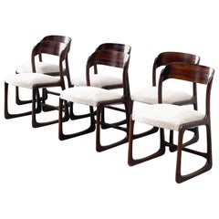 four rosewood and bouclé dining chairs by Emile and Walt Baumann