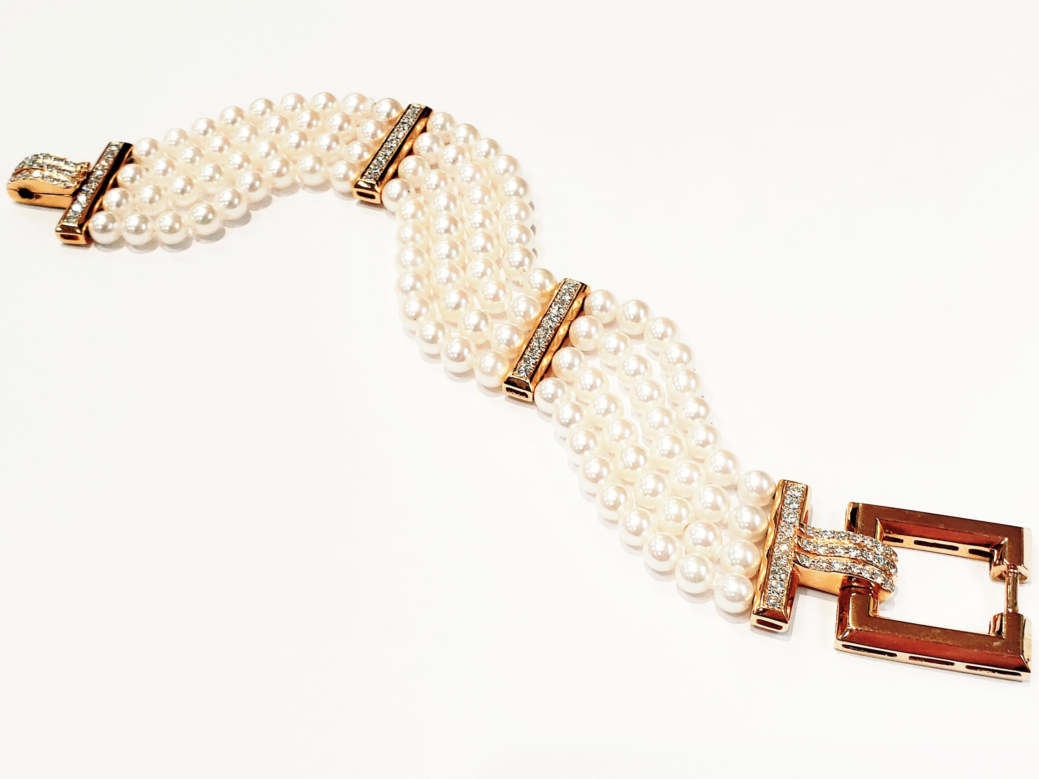 A Four Row Cultured Pearl Bracelet, With 18 Karat Yellow Gold And Diamond Spacers, And Clasp.
Each Section Has Four Rows, Each With Nine Pearls. Between Sections, Is A Gold Bar Set With Nine Round Diamonds.
Clasp Is A Gold Open Square, With Diamond