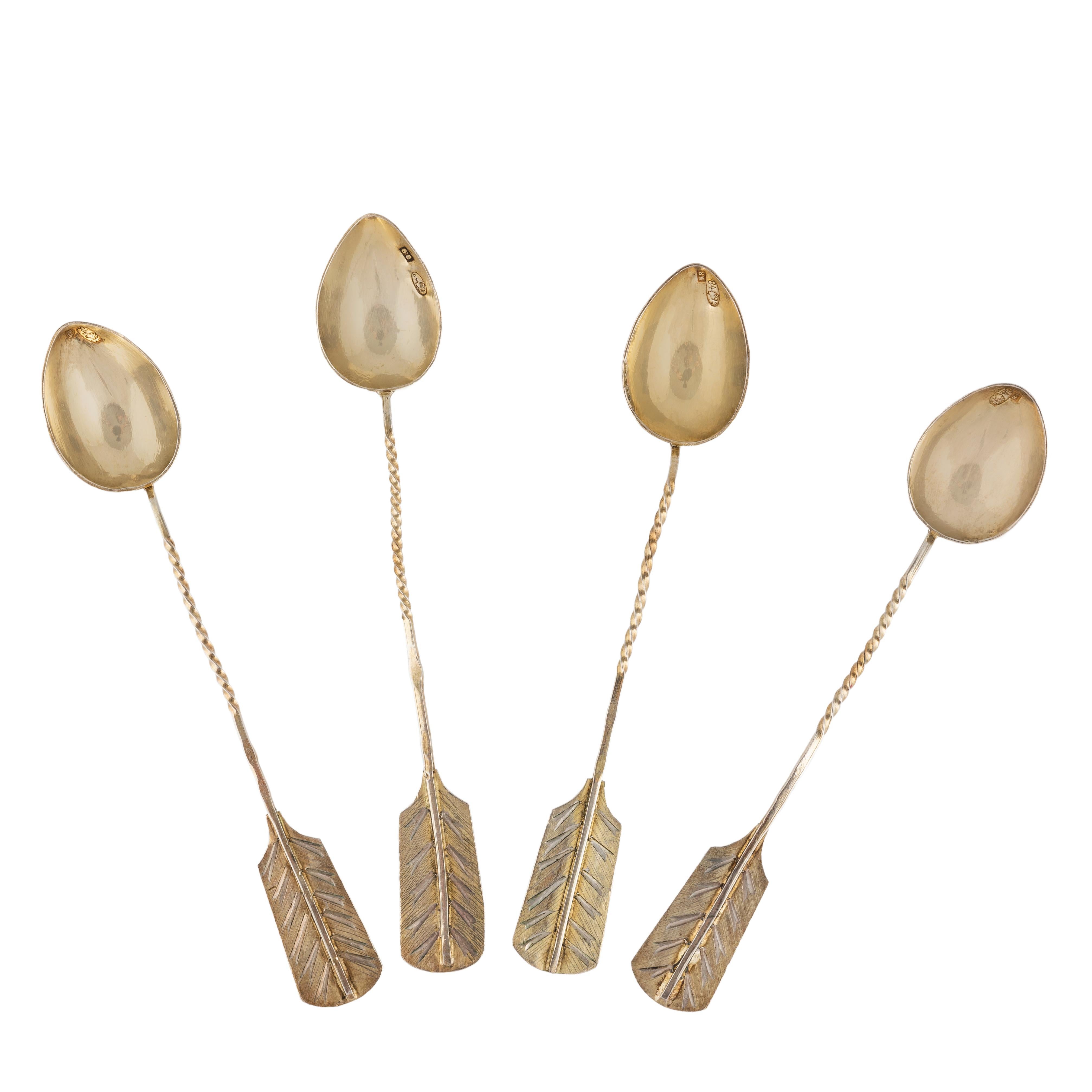 A set of four delightful Russian silver-gilt or vermeil demi-tasse coffee spoons, the handles in the shape of arrow feathers, with twisted stems and engraved exterior bowls typical of that period. The silver is gilded throughout with the original
