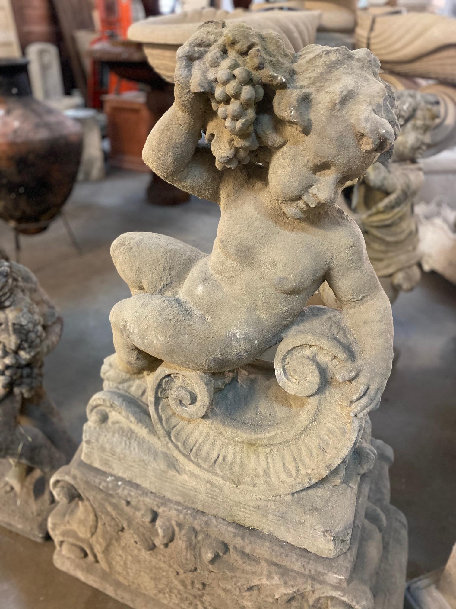 This statue is part of a Four Seasons Putti collection, this lounging putti statues with grapes represents 