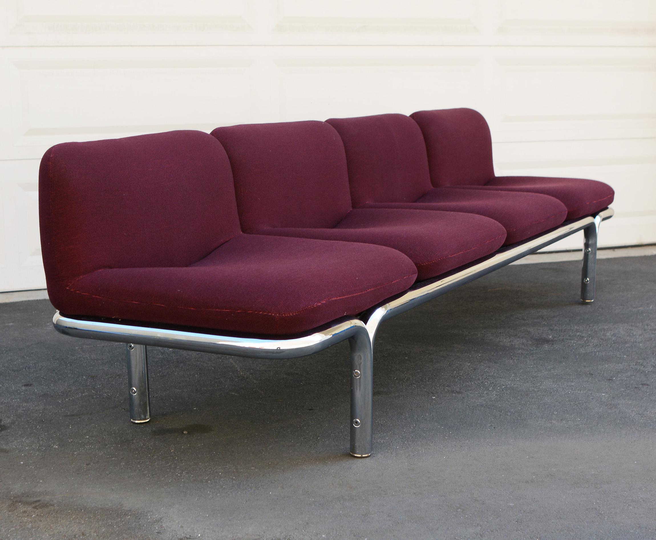 Series 10 sofa designed by Brian Kane. The sofa has a tubular chrome frame with four separate upholstered seats. This sofa is nine feet long. The chrome shows normal wear with some light scratches on the ends. The upholstery is older but in good