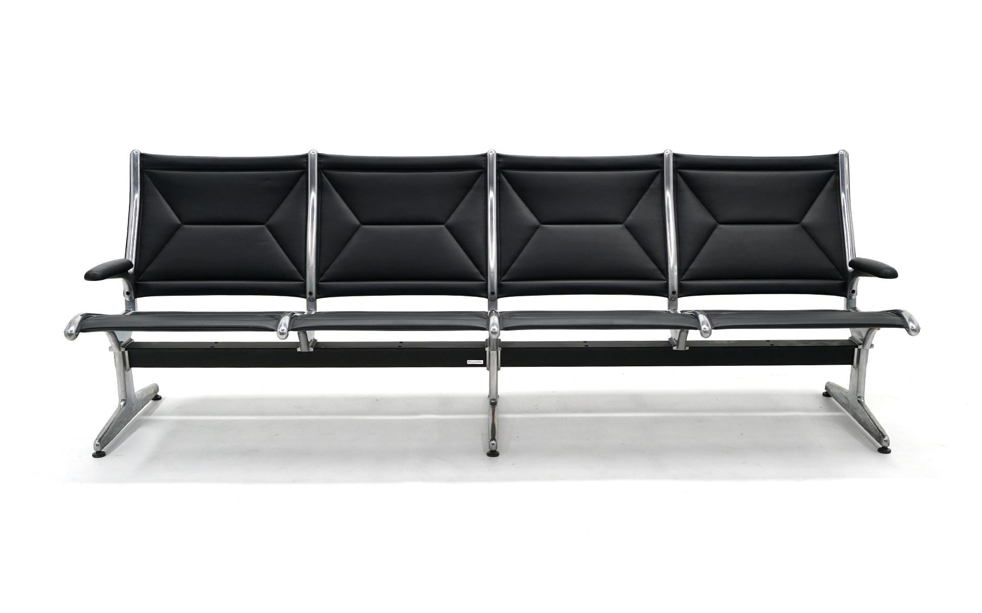 Tandem sofa seating for four designed by Charles and Ray Eames for Herman Miller. This piece only has arms on each end so is much more inviting for residential or office use. Very good condition. Black leather and cast aluminum. Ready to use.