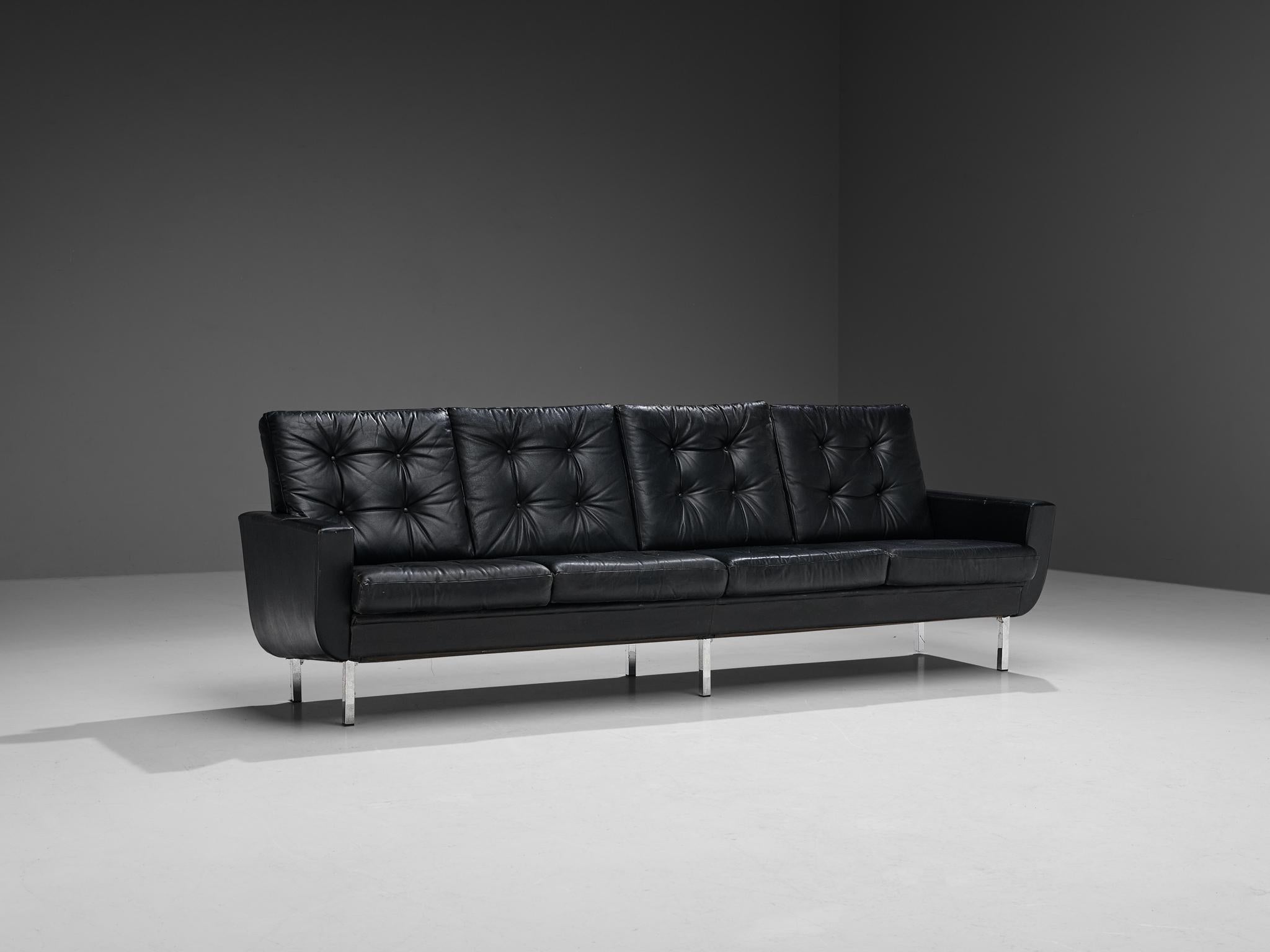 Four-seater sofa, leatherette, steel, Europe, 1960s. 

Sizeable sofa that could easily seat four or more people. This sofa is simplistic, yet stylish in its design. Due to the overall black color of the leatherette upholstery, the sofa radiates