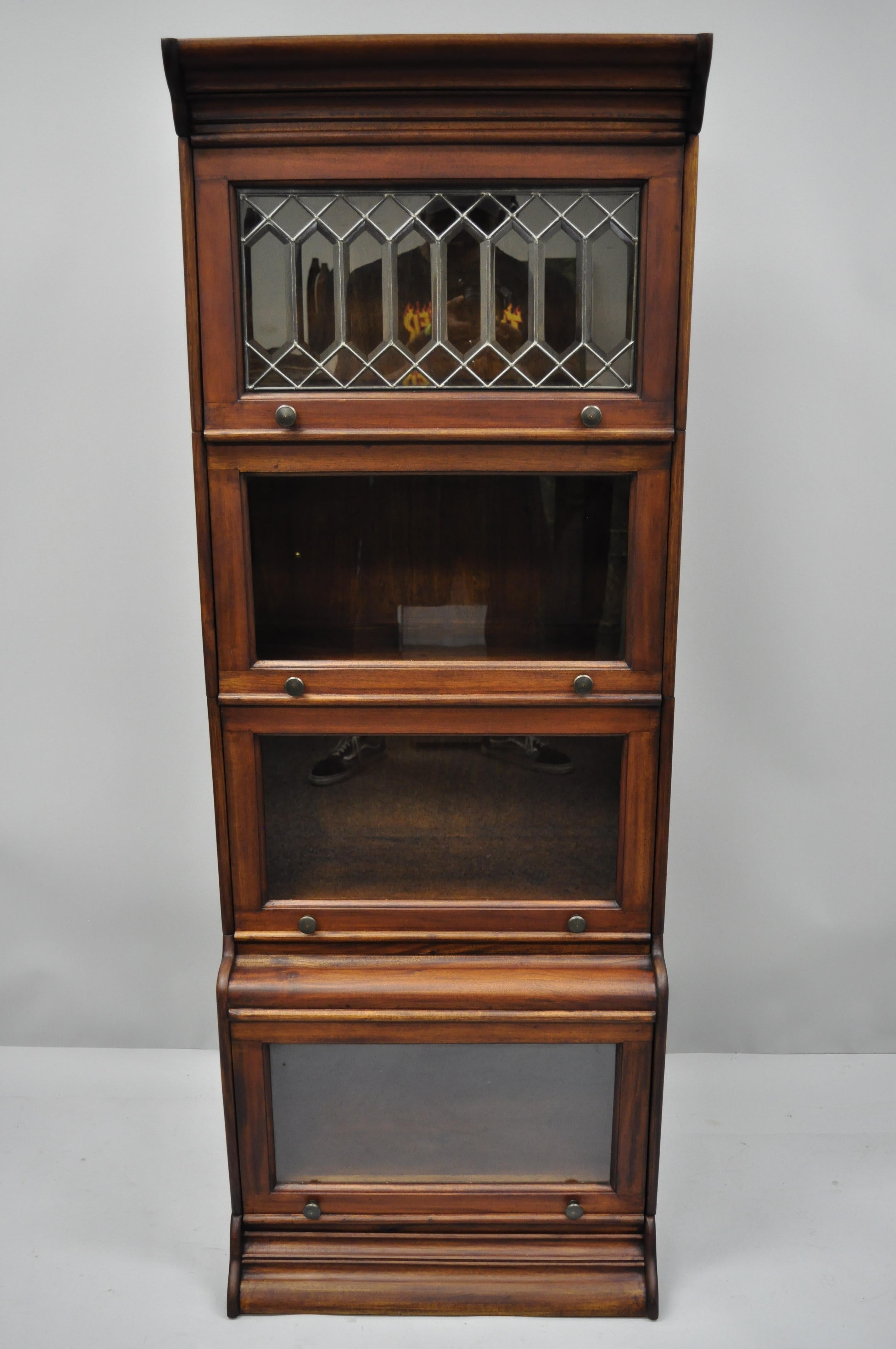 Four-section tall narrow barrister lawyer bookcase with leaded glass door. Listing includes top, bottom, and four bookcase sections. Also features leaded beveled glass door, solid wood construction, beautiful wood grain, six part construction,