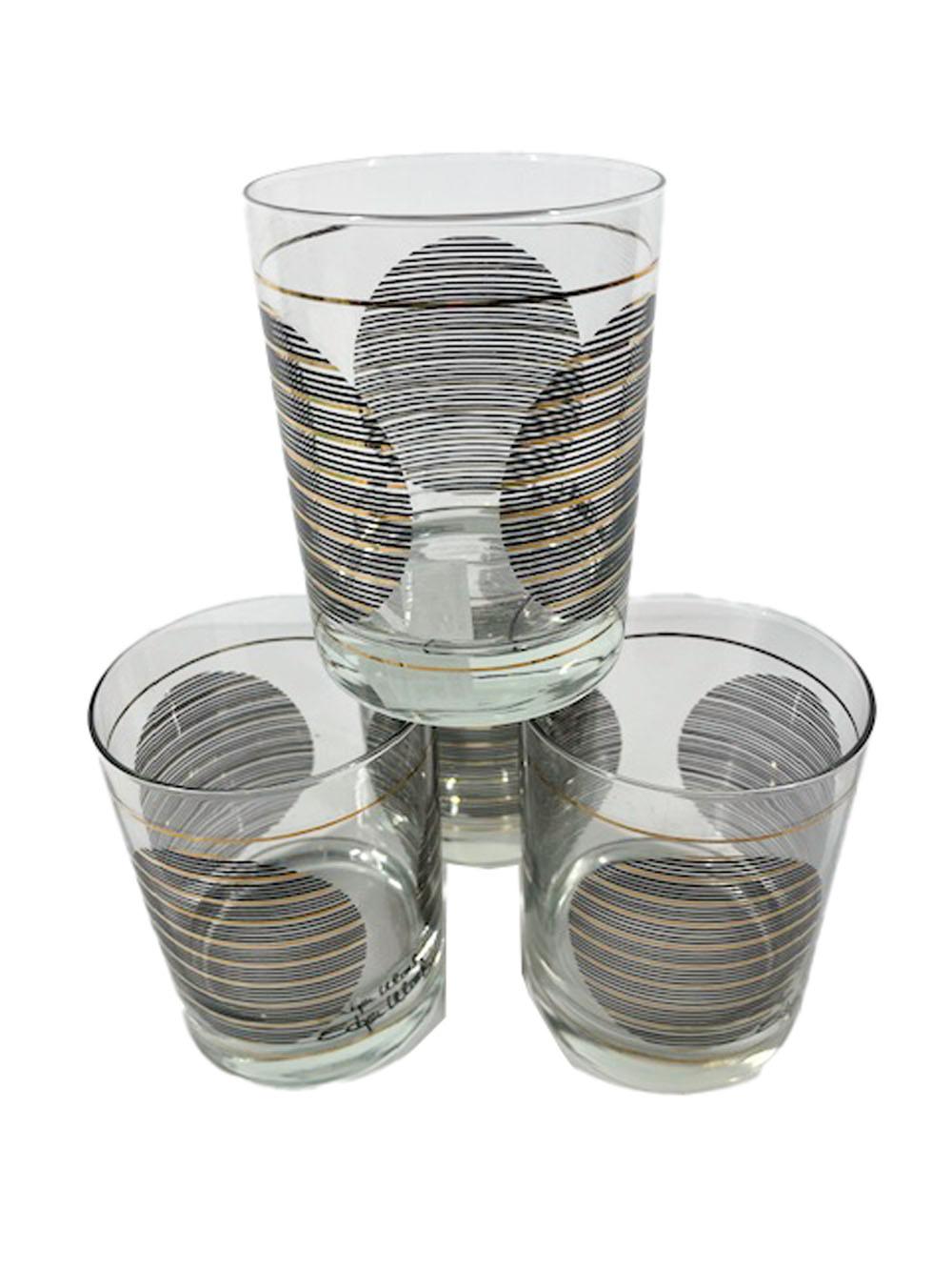 Set of four Shelton-Ware double rocks glasses decorated with three disks made of a series of fine lines in black enamel with every fifth line being 22k gold.