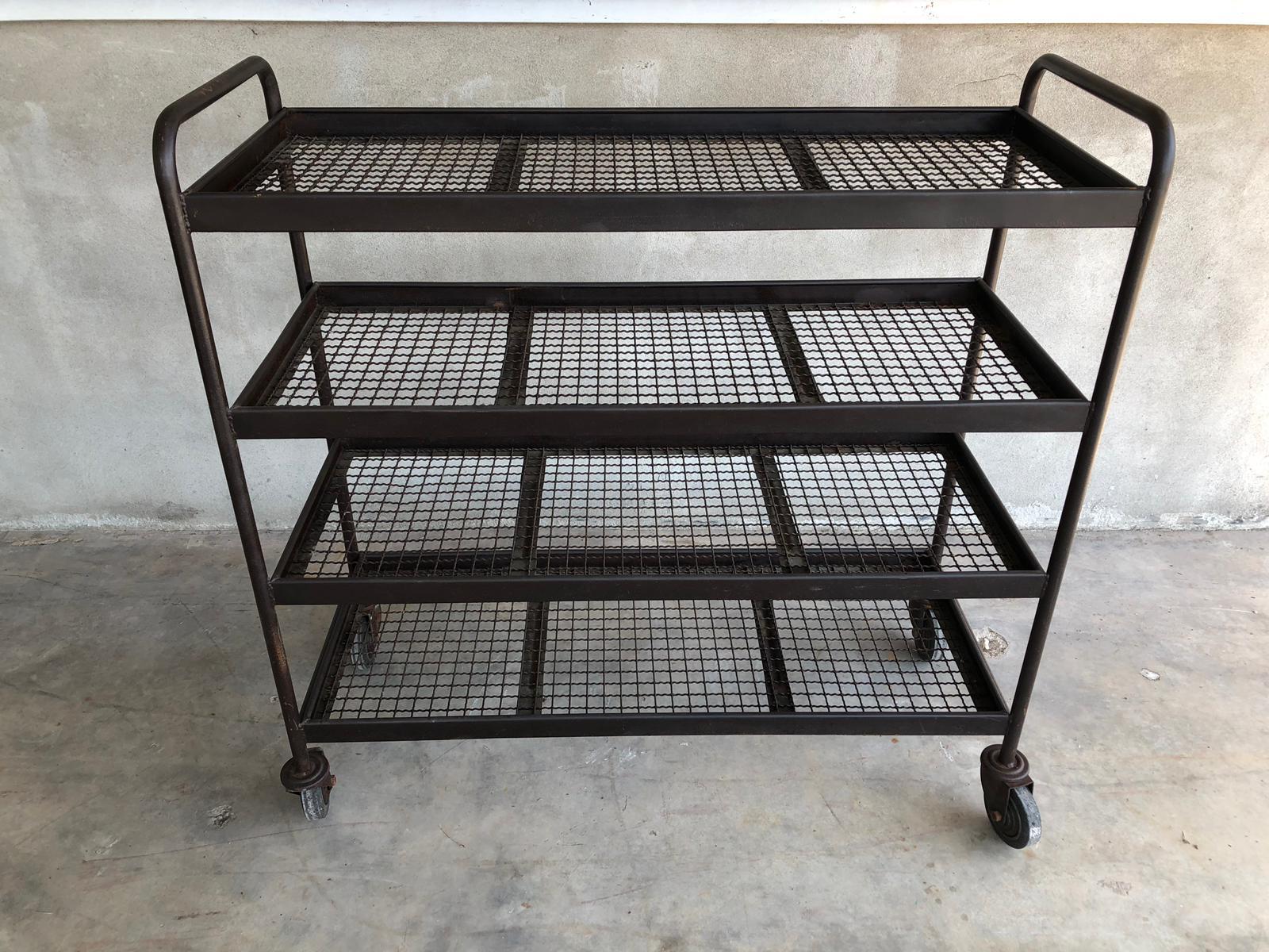 Four shelves industrial iron wheeled trays.

Industrial iron wheeled trays with or without wooden shelves. From Italy from midcentury period.
Trolleys are made of Industrial tubular iron with net shelves.
These pieces can be easily set in many