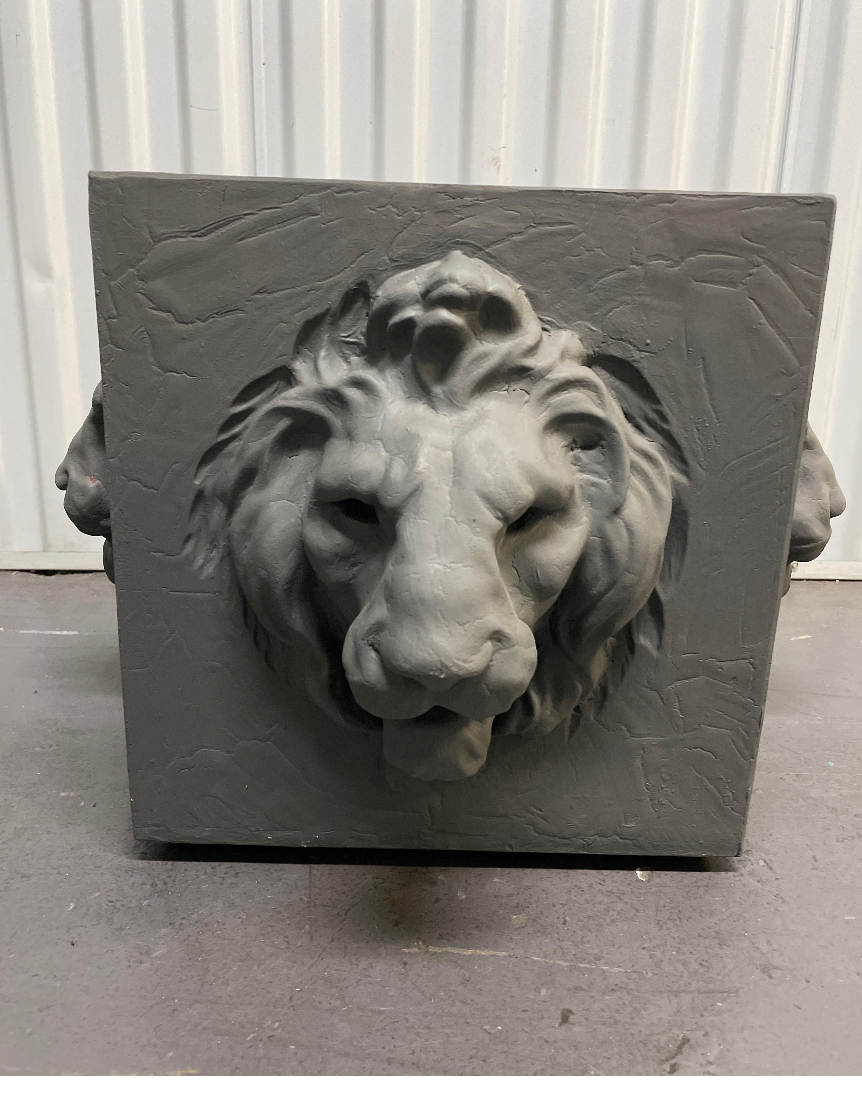 Square four sided lion head planter in a dark grey finish.