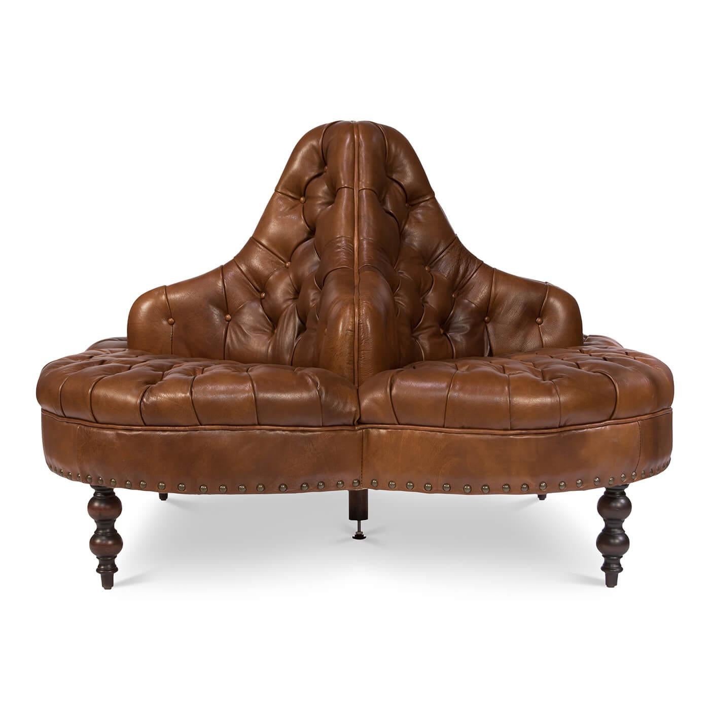 A Classic style four-sided sofa ideal for a large lobby or foyer. With vintage style brown tufted leather upholstered backrests and seats, raised on turned mahogany feet and finished with brass nailhead trim.

Dimensions: 57