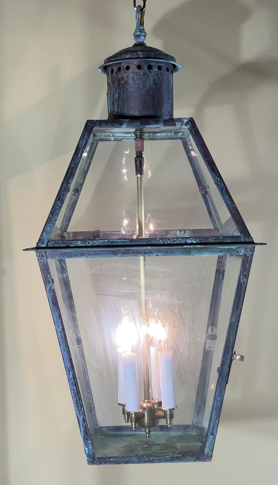 Quality handmade solid copper lantern with four 60/watt lights.
Electrified and ready to use, Beautiful oxidization patina. Suitable for wet locations or indoor 
Chain and canopy included.