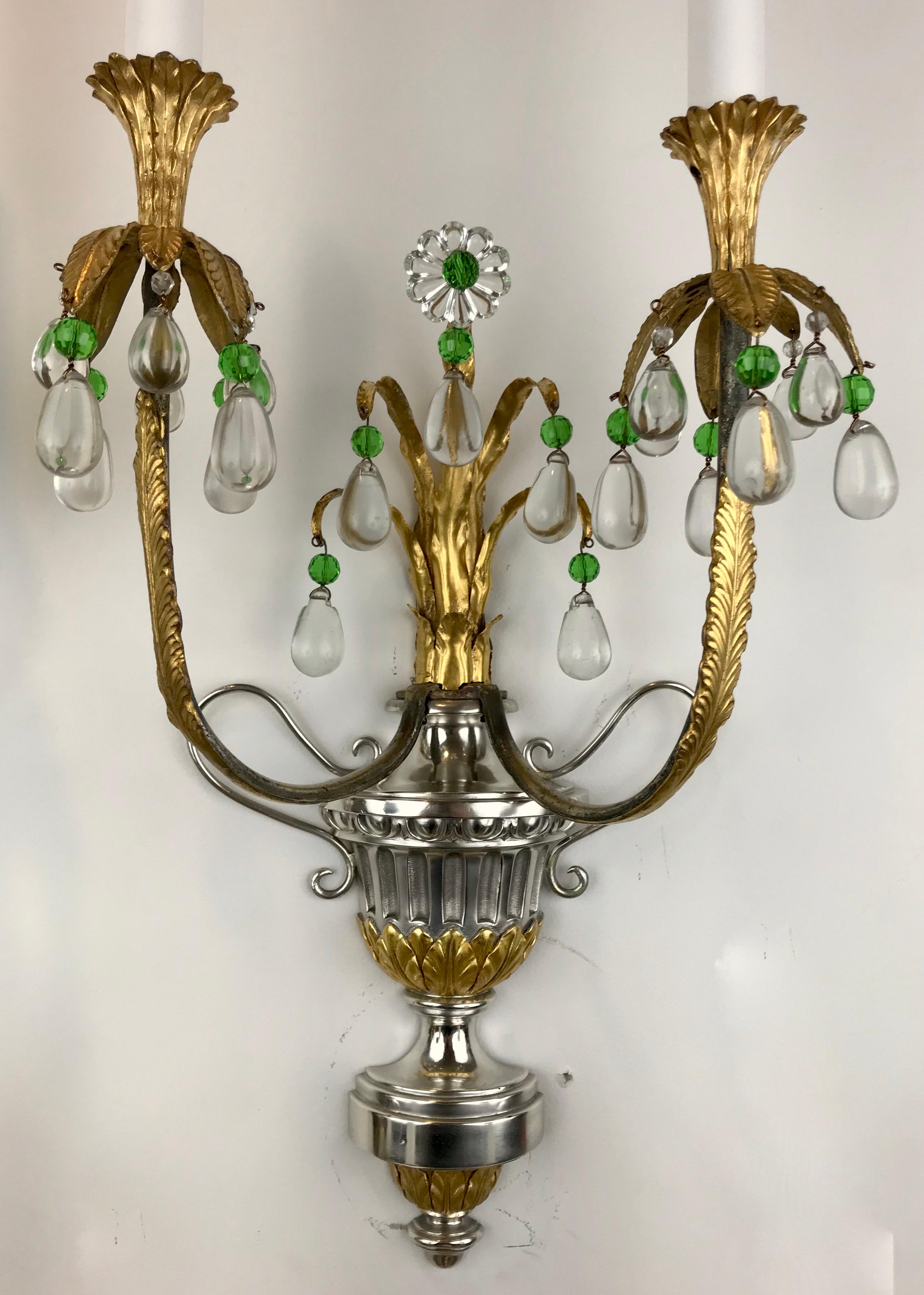 This set of four signed E.F. Caldwell sconces consisting of campana urn form backplates, issuing gilt foliate sprigs, terminating in emerald and clear crystal drops. They are beautifully hand made, and can be found pictured in the Caldwell archives