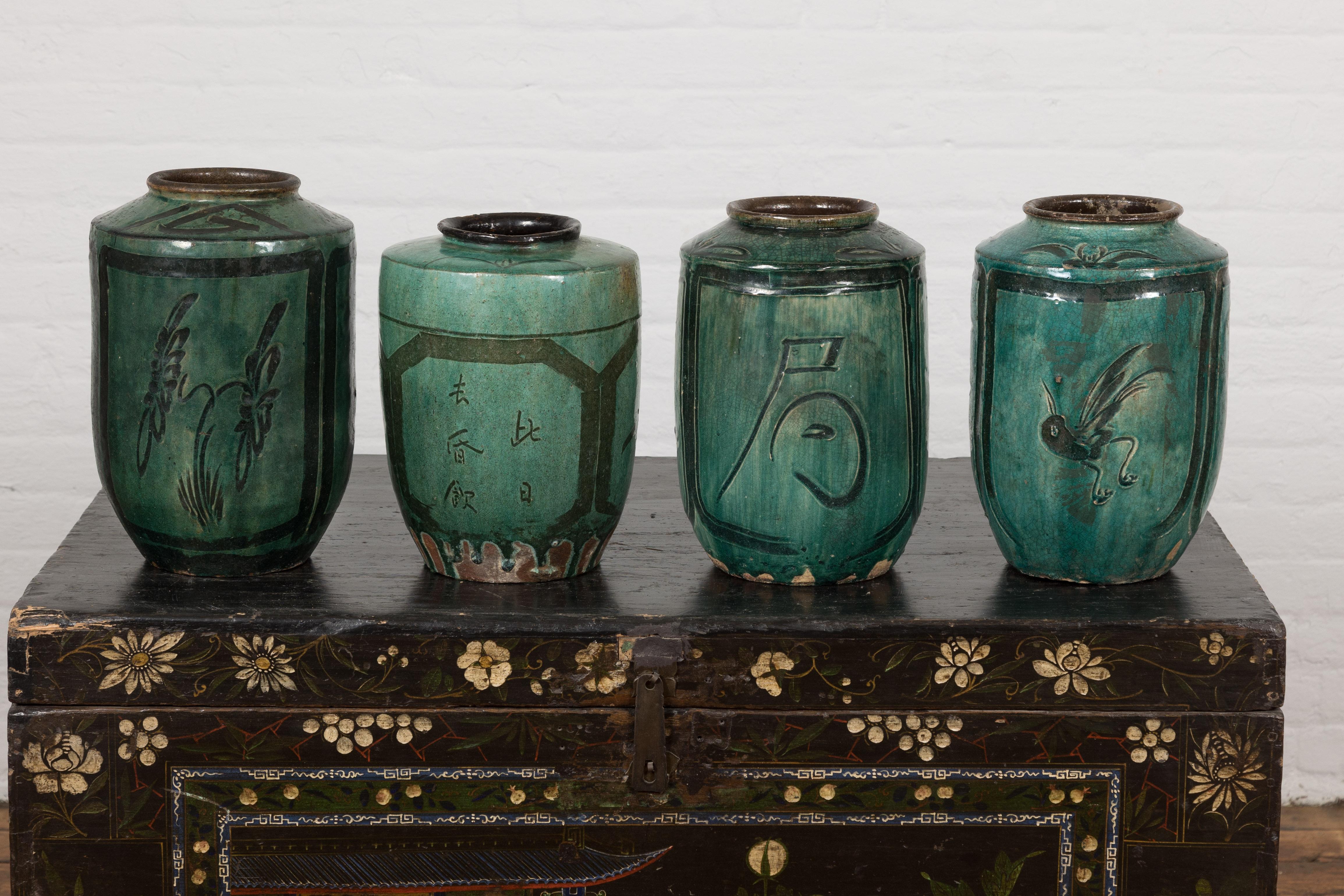 Four small Chinese Qing Dynasty period green glazed ceramic rice wine jug vessels from the Hunan Province, priced and sold individually. Beckoning from the depths of Chinese history, this quartet of Qing Dynasty rice wine jug vessels from the Hunan