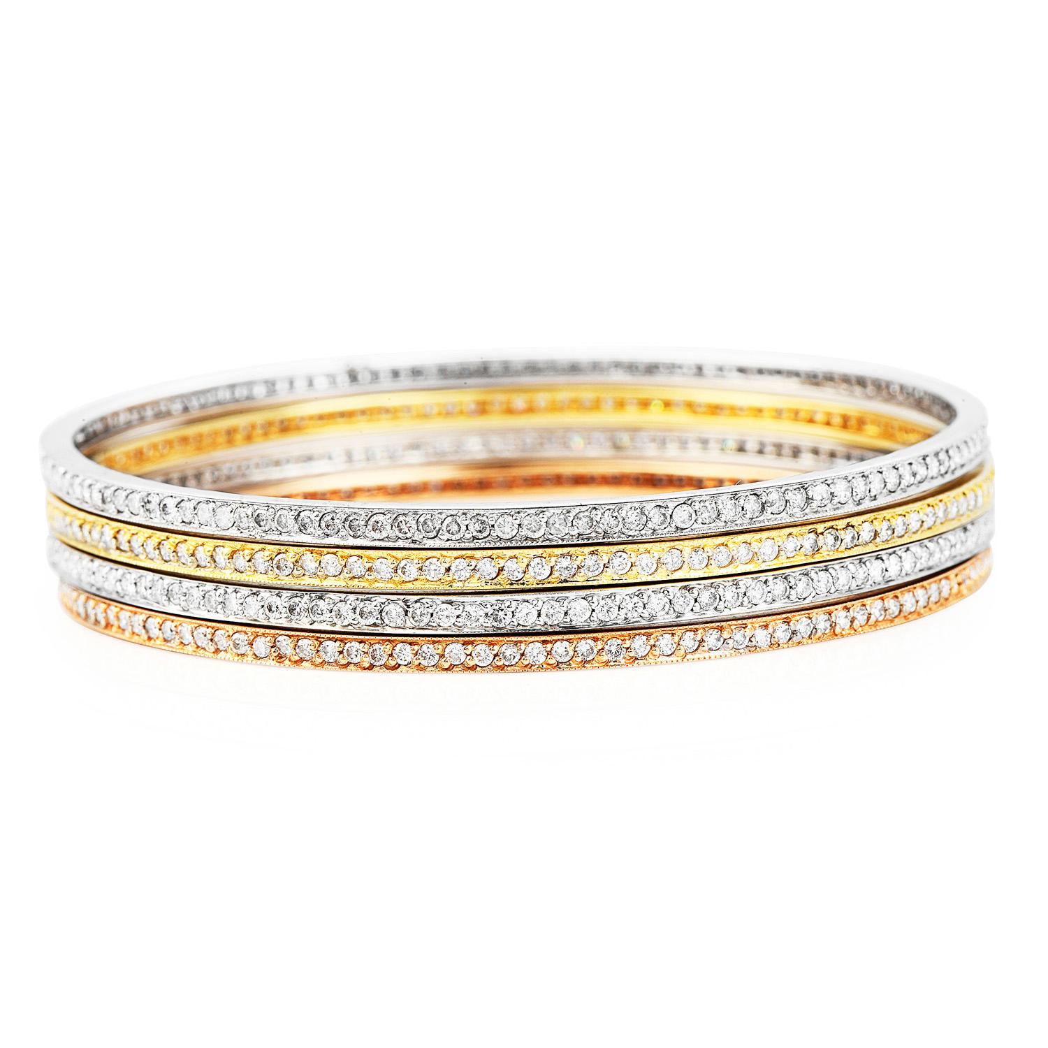 These stackable 4-eternity diamond bangles bracelets are crafted in 18 karat yellow, rose and white gold, weighing 40.6 grams in total and measuring 7 inches around the waist circumference, with a width of 11 mm. 

Each bangle set throughout with