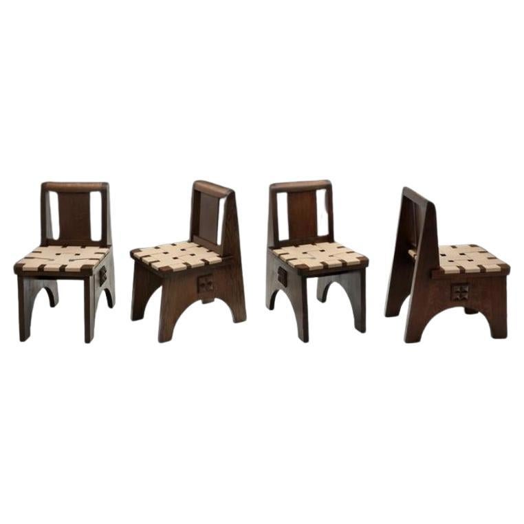 Quatre chaises en chêne teinté à la manière de Charles Dudouyt, France 20e siècle
