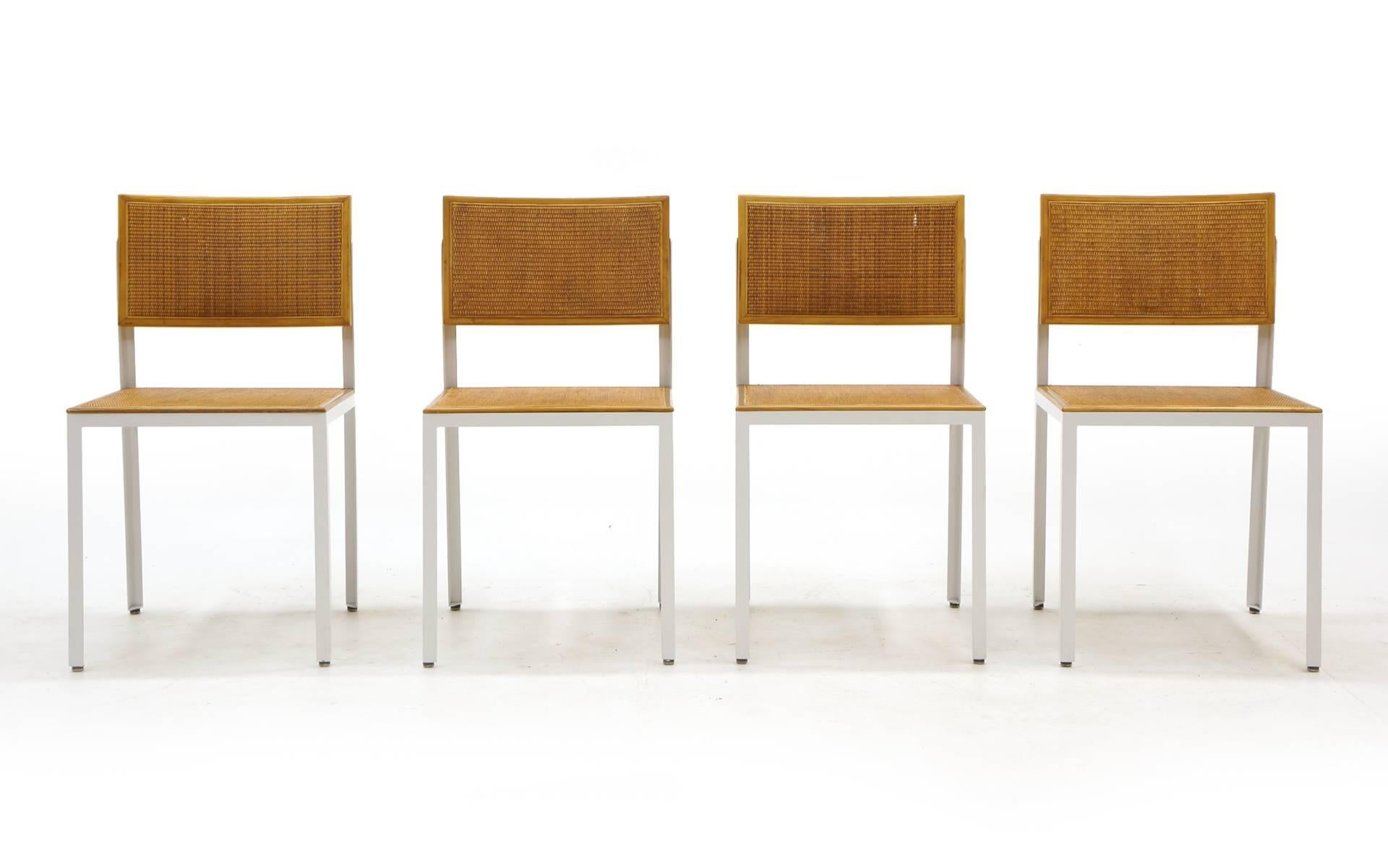 Rare set of four steel frame group dining chairs designed by George Nelson for Herman Miller. The original cane is in excellent condition. See our listing for the rosewood Nelson lazy susan dining table we purchased with these chairs.