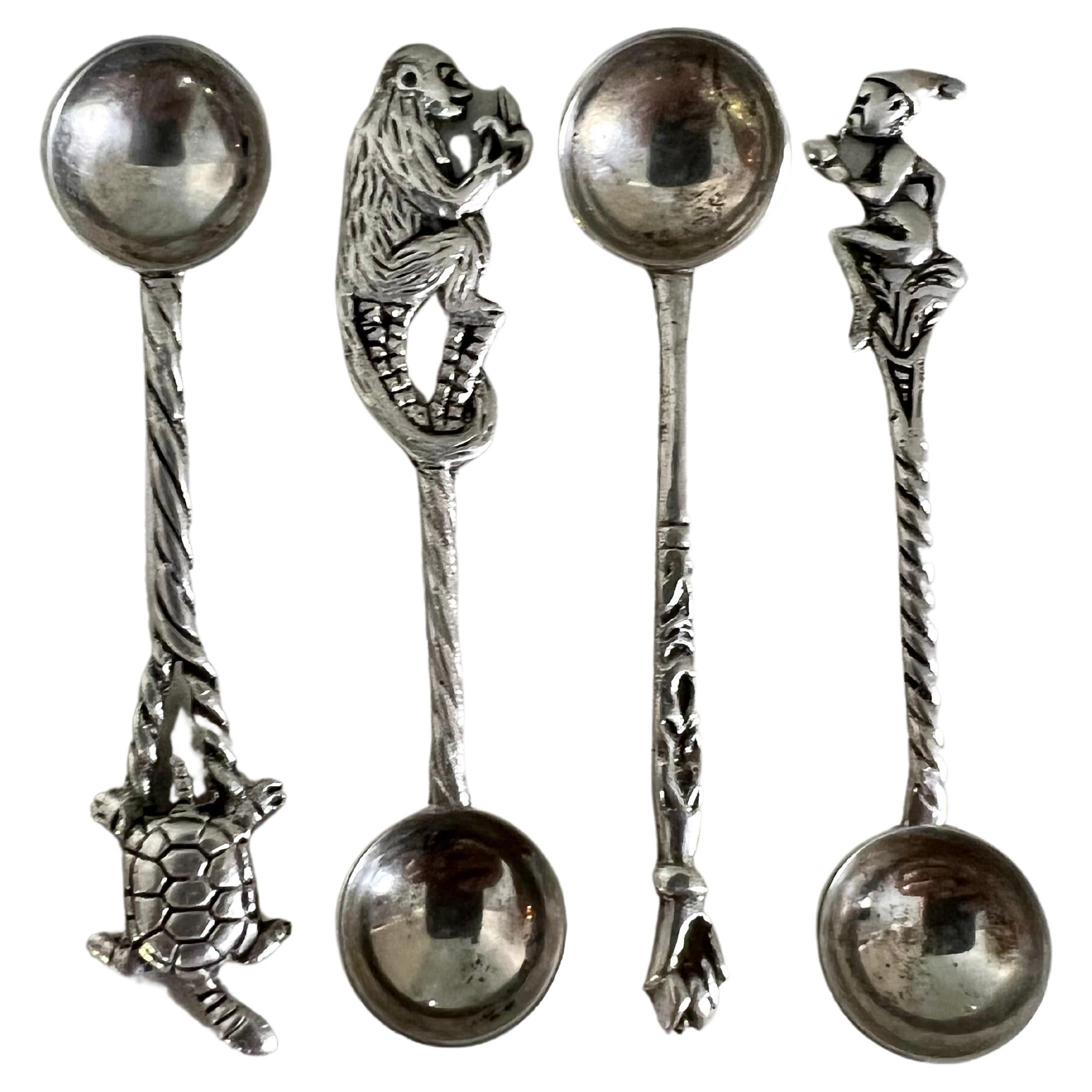A wonderful set of four sterling silver spoons, each with a different handle, Elf, Monkey, closed fist, turtle - traditionally used for salt cellars, but moving into the 21st century, be creative!! Really a wonderful set.