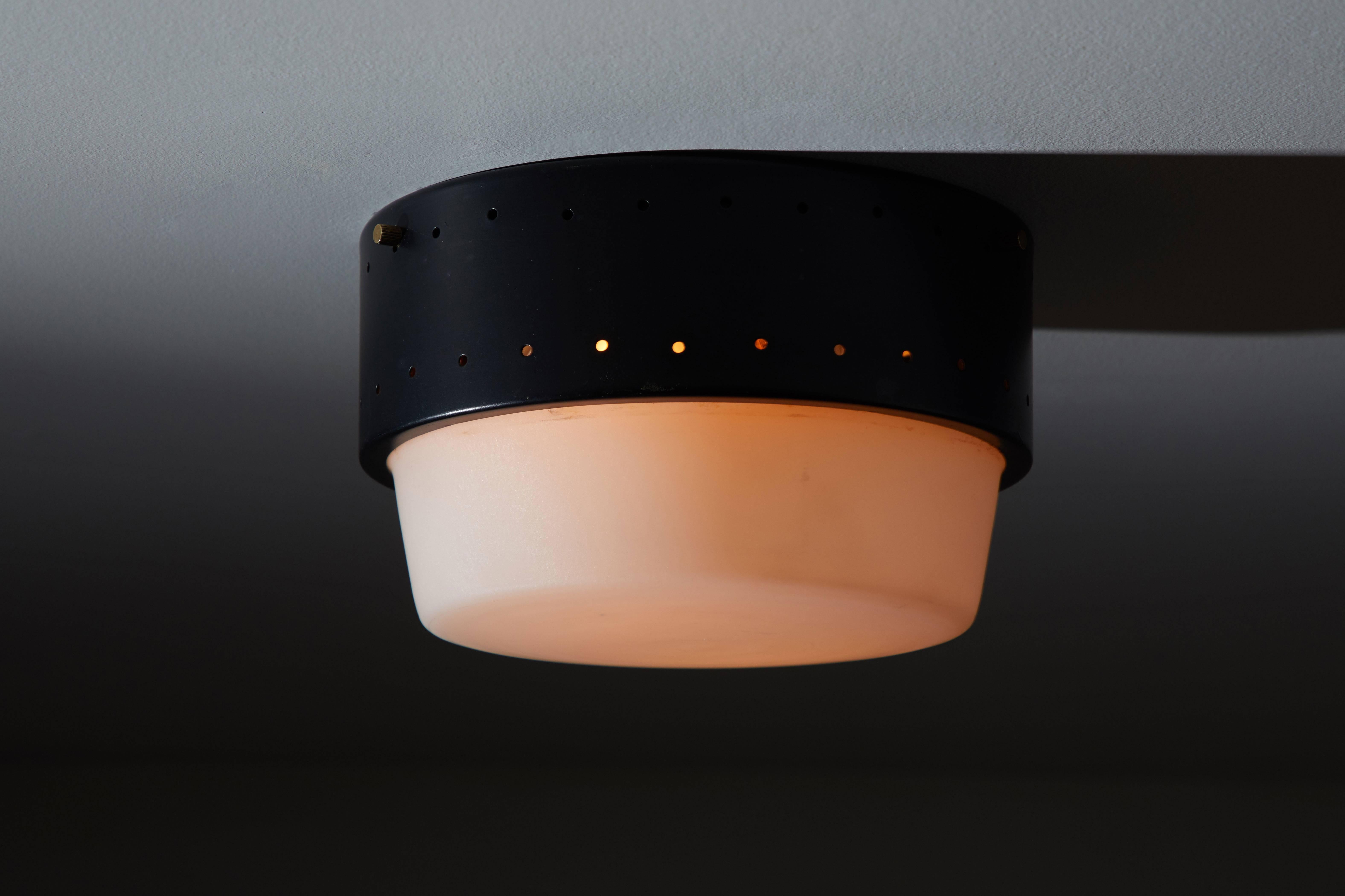 Stilnovo Flush Mount Ceiling Light manufactured in Italy, circa 1960s. Enameled metal and brushed satin glass. Wired for US junction boxes. Takes one E27 100w maximum bulb. Priced and sold individually. ONLY ONE LIGHT AVAILABLE ALTHOUGH THE IMAGE