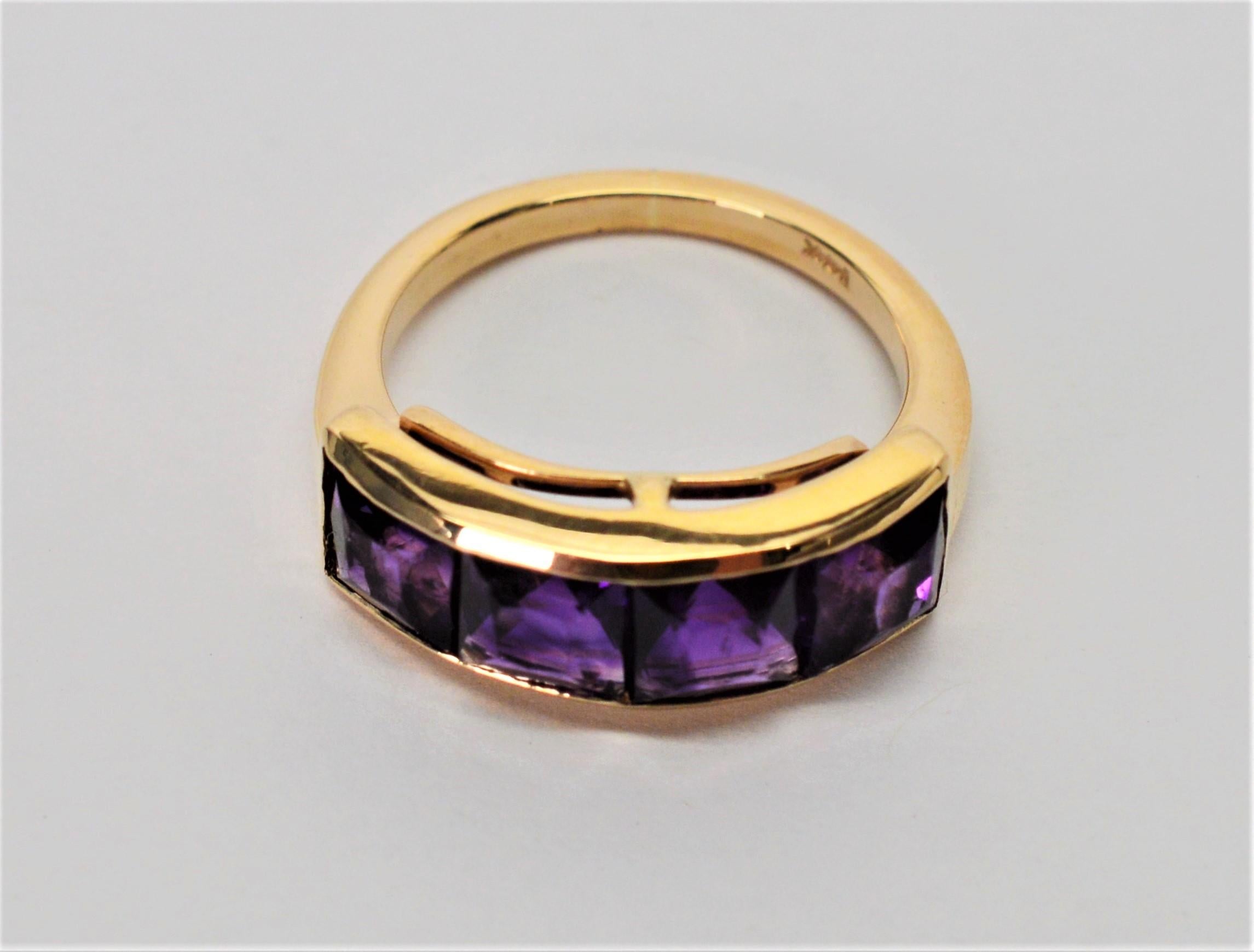 Four vivid deep purple 5 x 5 mm natural amethyst stones face this fourteen karat (14K) yellow gold band in ring size 5. With a total weight of two carats (2 carats TW), the emerald cut amethysts wrap with warmth and elegance. 
 