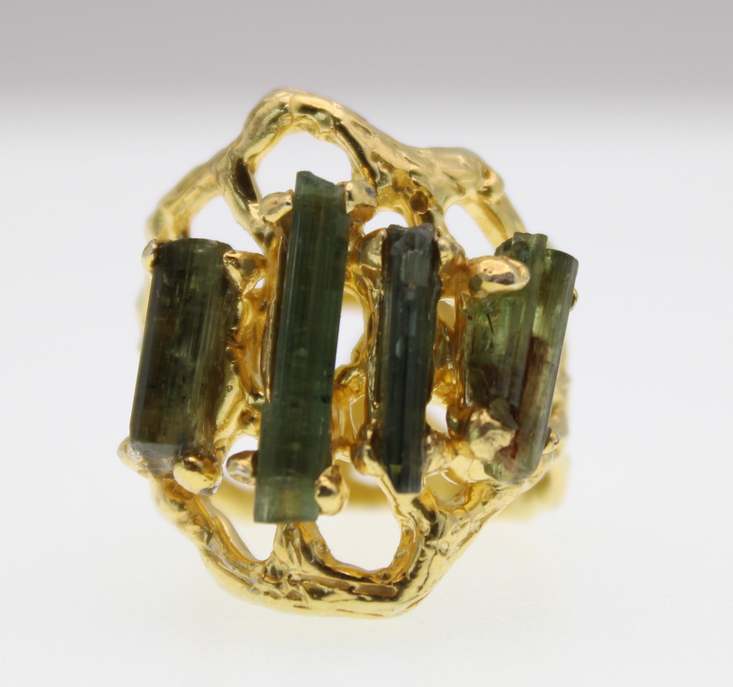 Stunning gold plated cocktail ring with 4 raw green tourmaline stones vertically set. This ring is a size 7.5.
Natural imperfections and striations in the tourmaline are present which gives this ring one-of-a-kind character.
