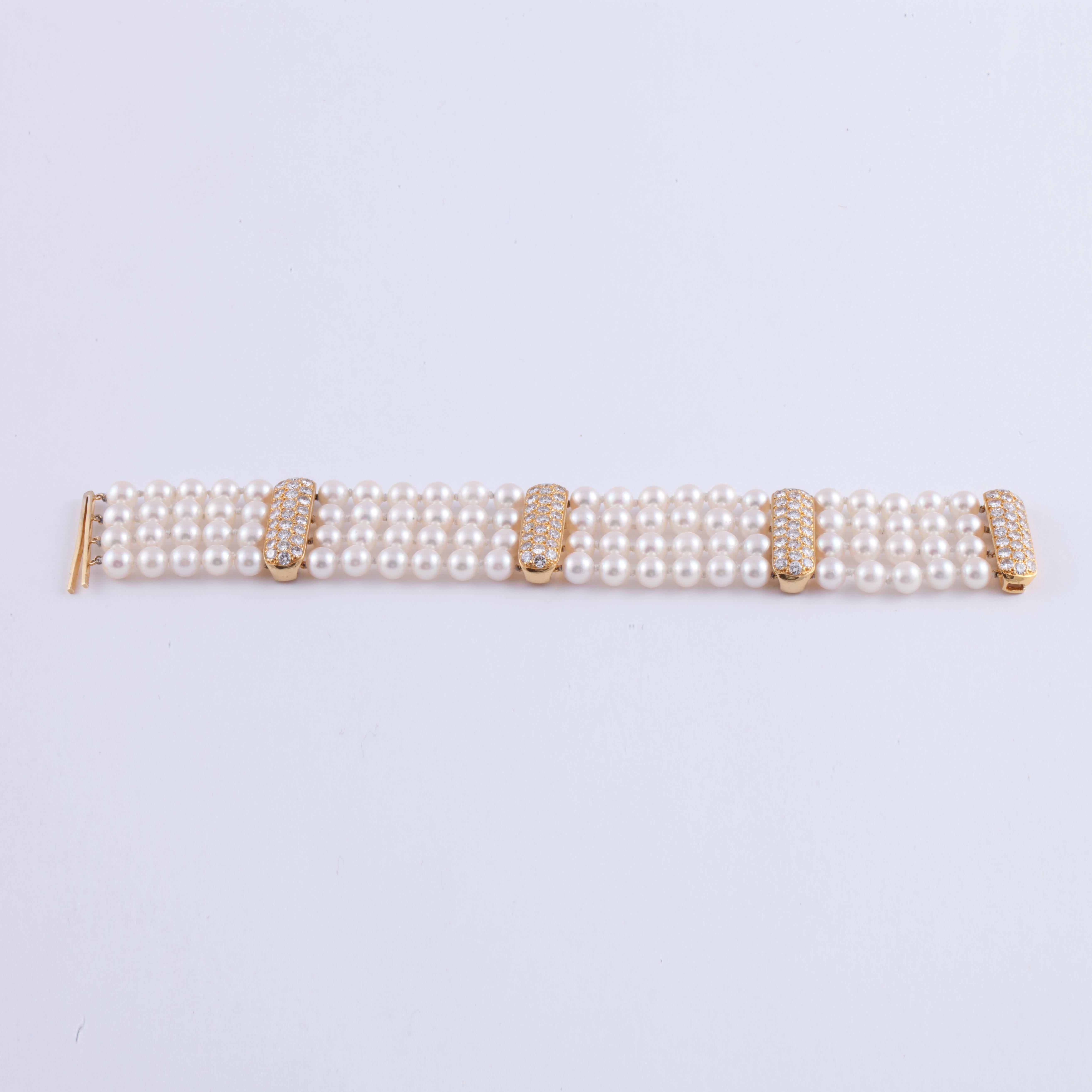 Four strand pearl bracelet featuring 88 cultured pearls that measure 6-6.5mm.  The 18K yellow gold spacers contain 7.35 carats of diamonds, G-I color and VVS clarity.  The bracelet measures 7 1/4 inches long and 1 1/16 inches wide.  Closure slides